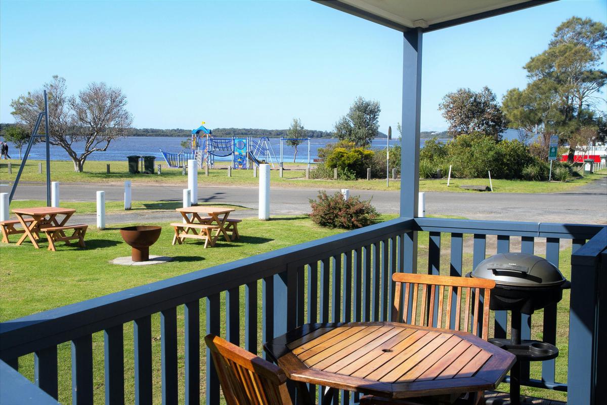 Waterfront One Bedroom Cabin - Deck with BBQ and Fire Pit on Grass