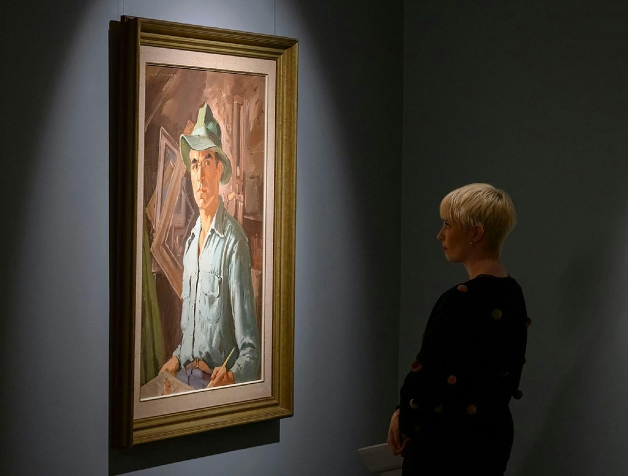 Viewer looking at artwork by Alan Baker