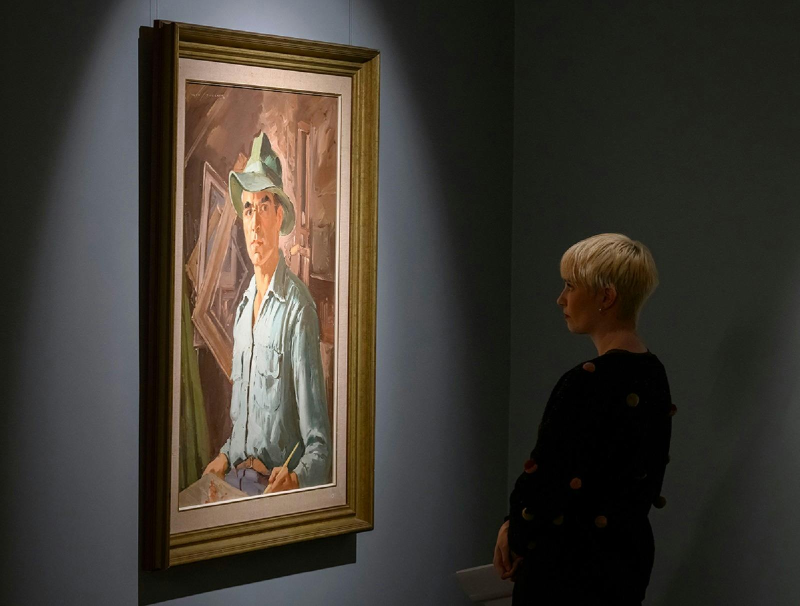 Viewer looking at artwork by Alan Baker