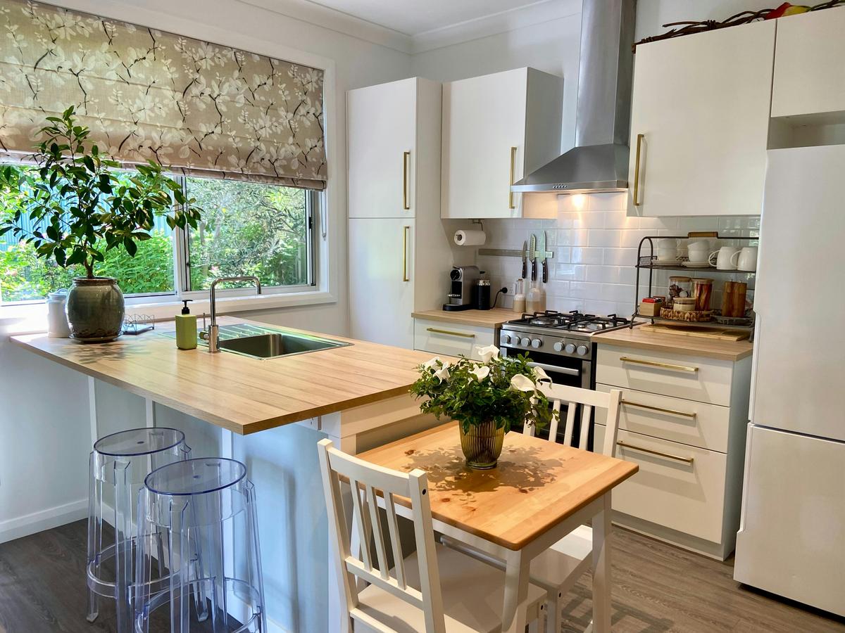 The sunlit kitchen is fully equipped with everything you need for meal preparation & dining.