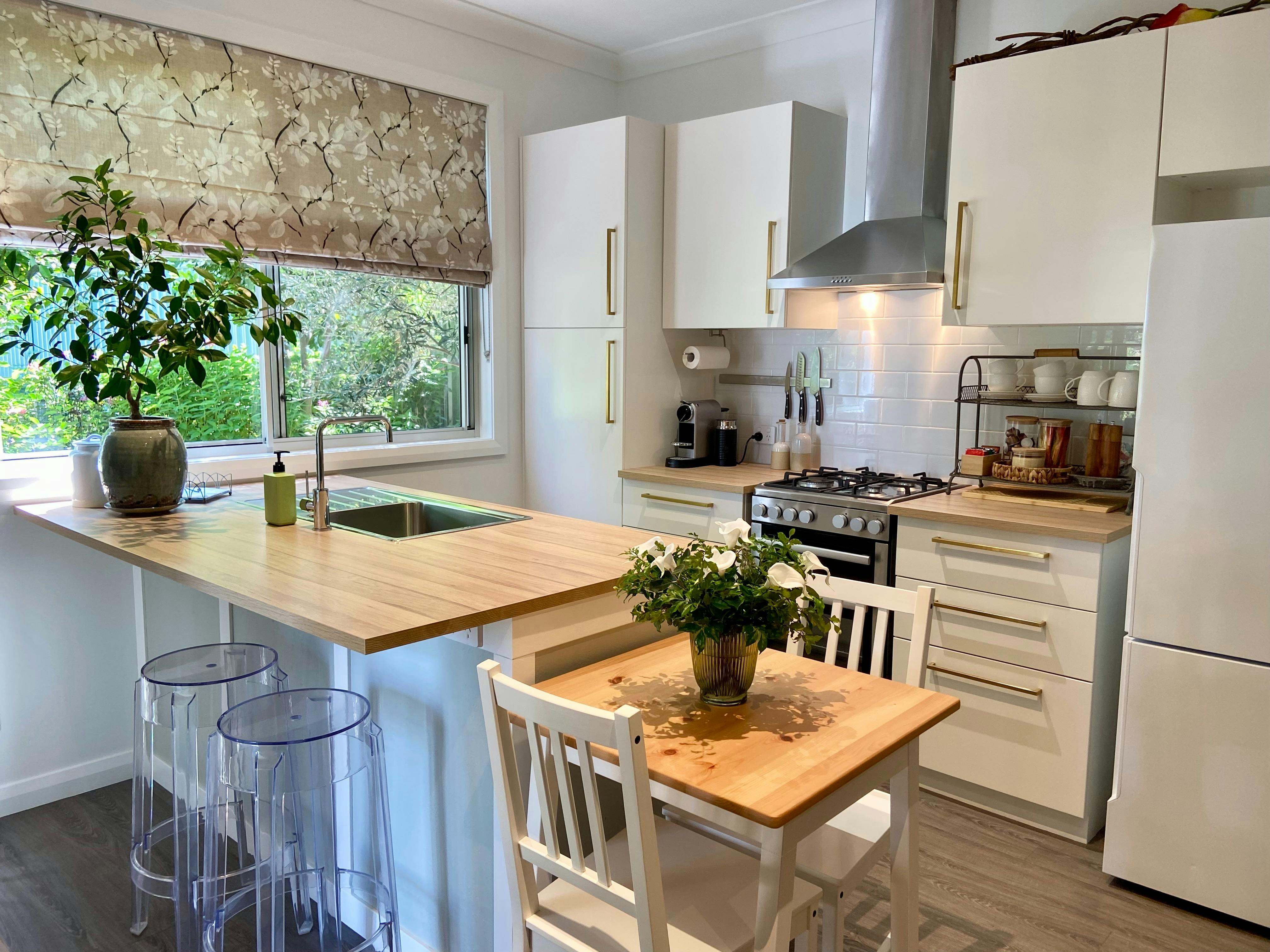 The sunlit kitchen is fully equipped with everything you need for meal preparation & dining.