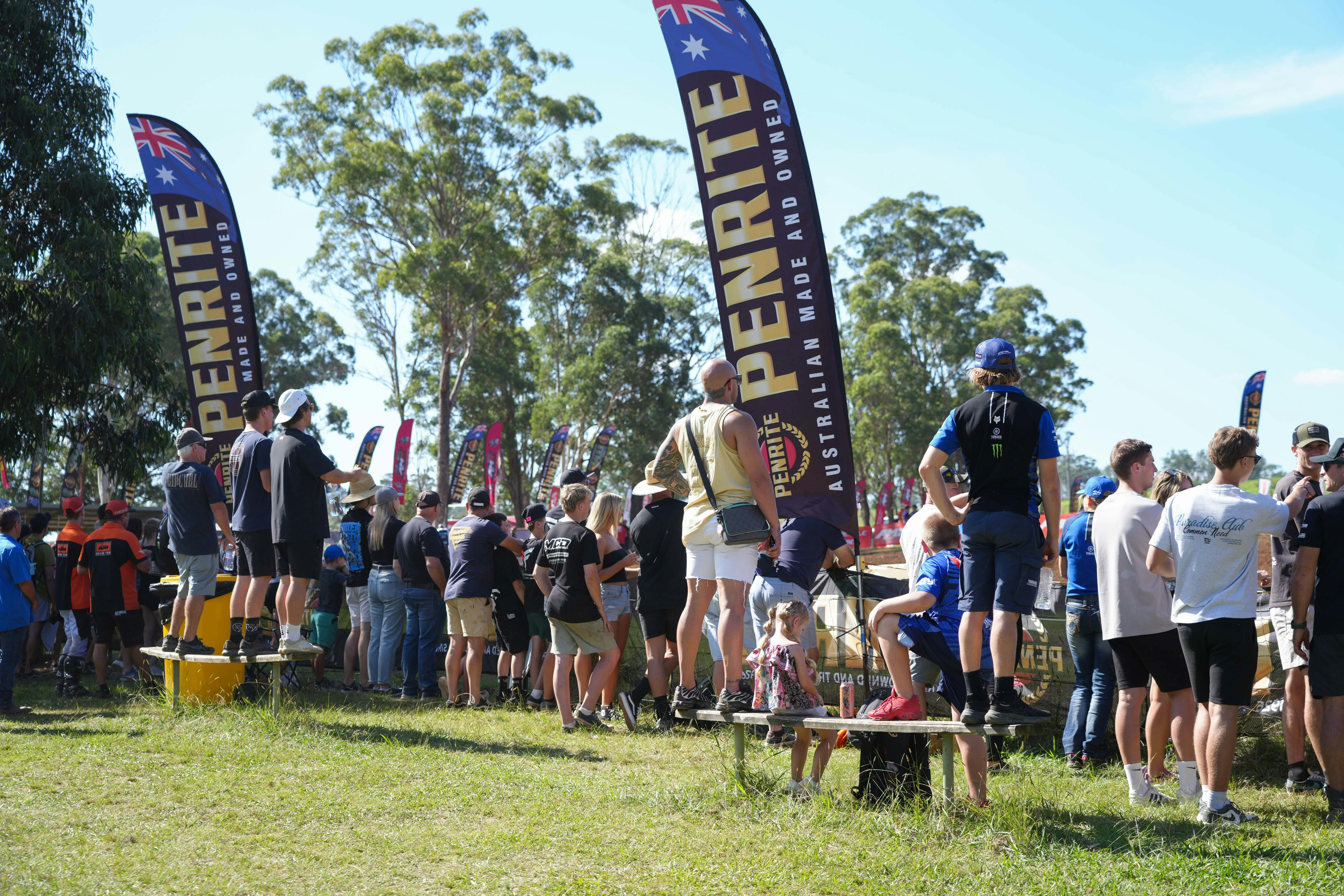 Fans line the fence, eager to watch the racing