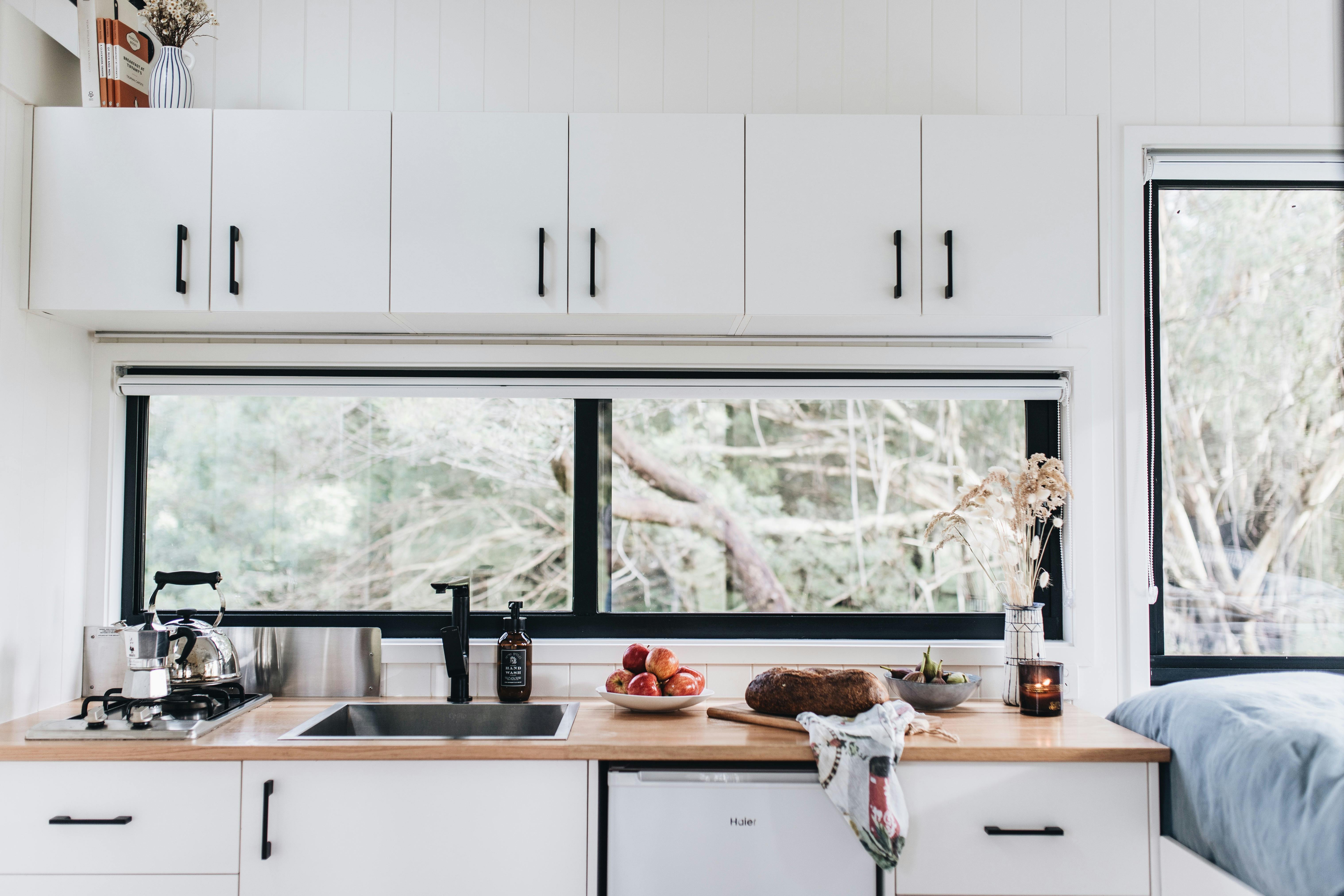 Kitchen with fridge, stove top and basic cooking essentials