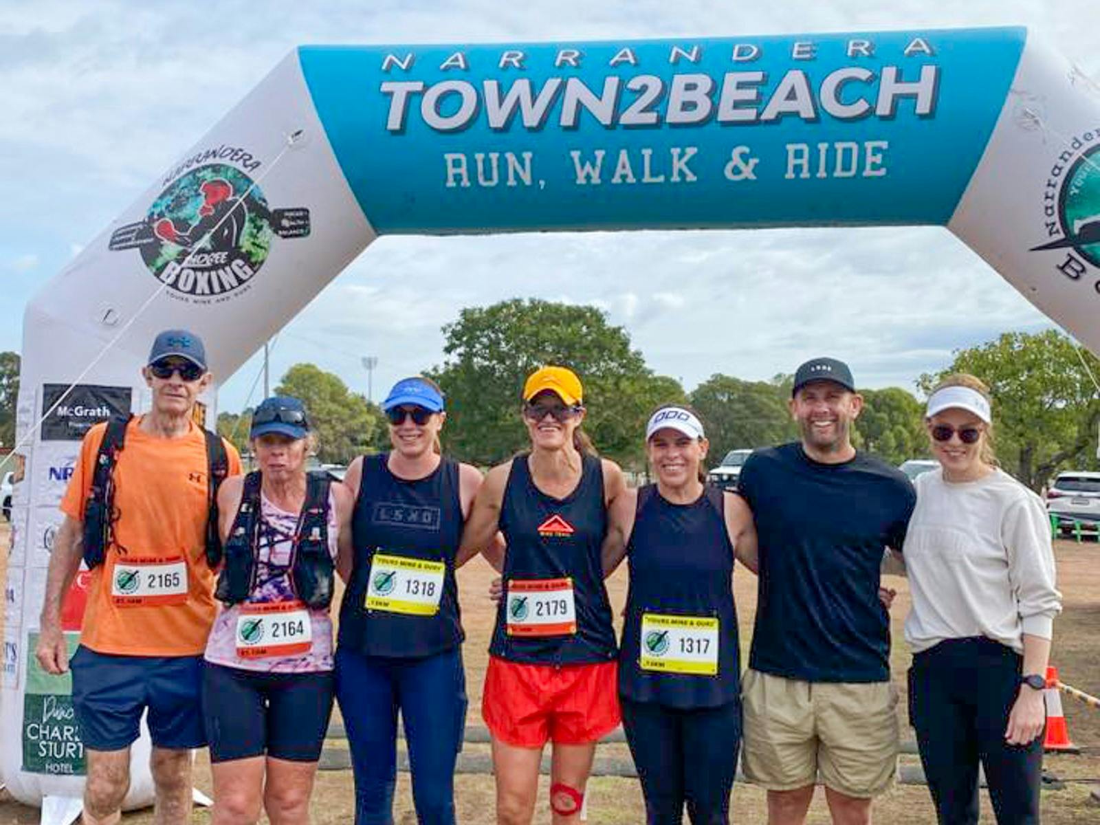 Competitors standing at the Town2Beach finish line in Narrandera