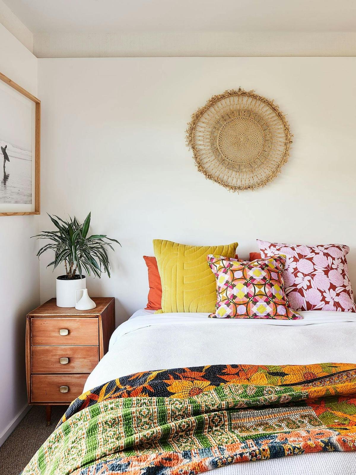 Bed with colourful pillows.