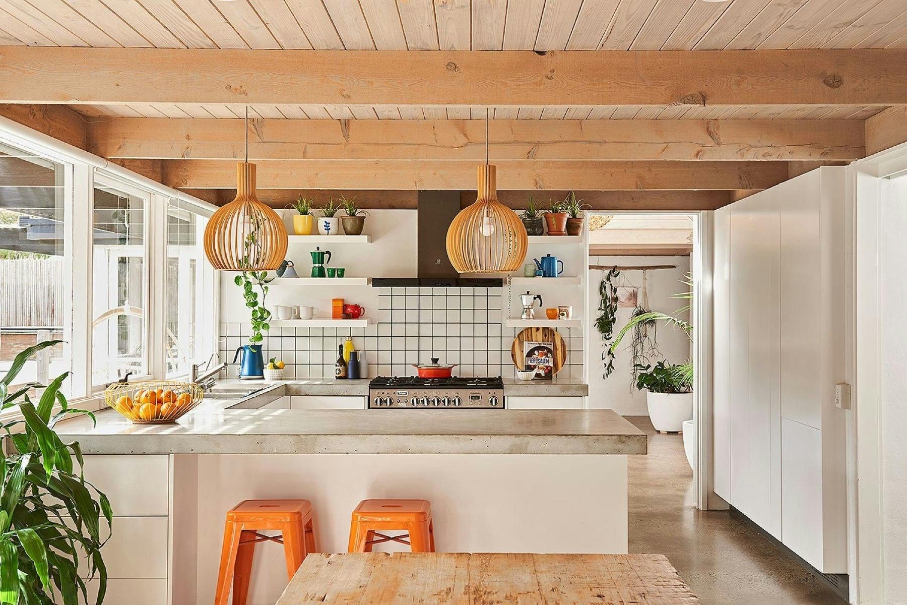 White kitchen with colourful furniture.