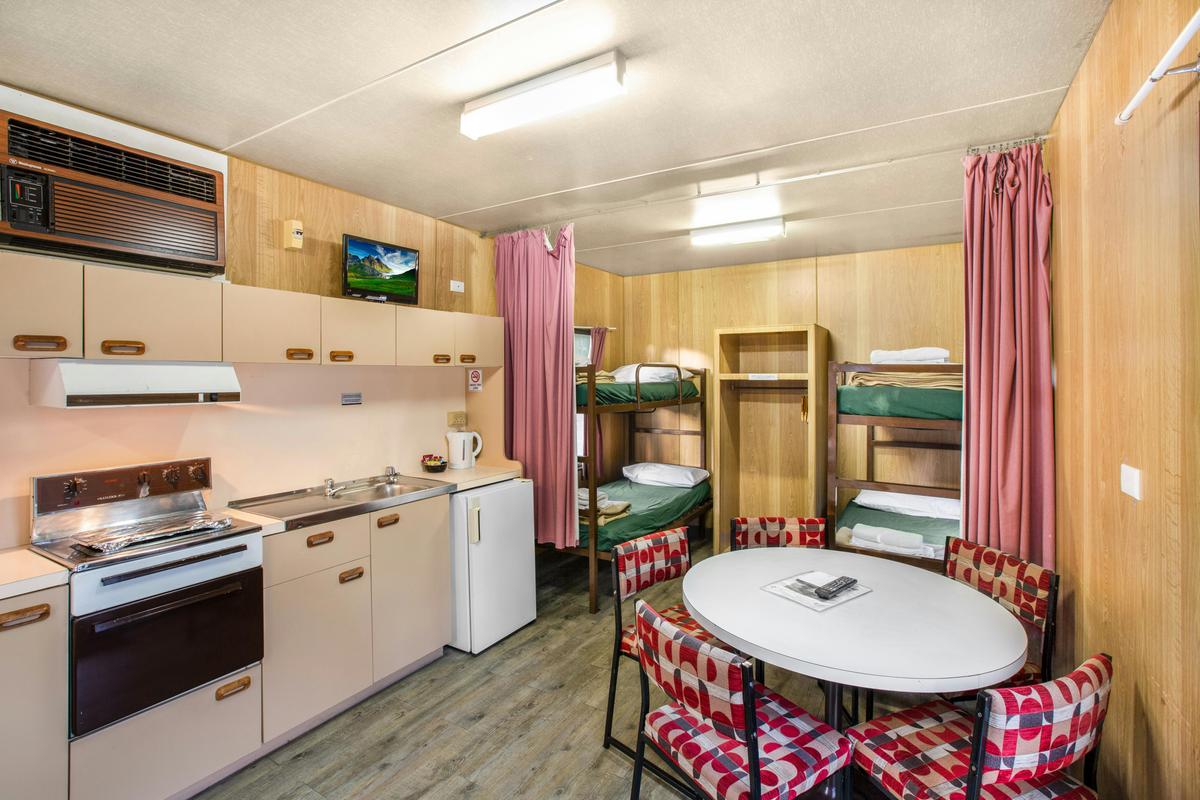 Kitchen, bunk beds and dining area in the Budget Cabin