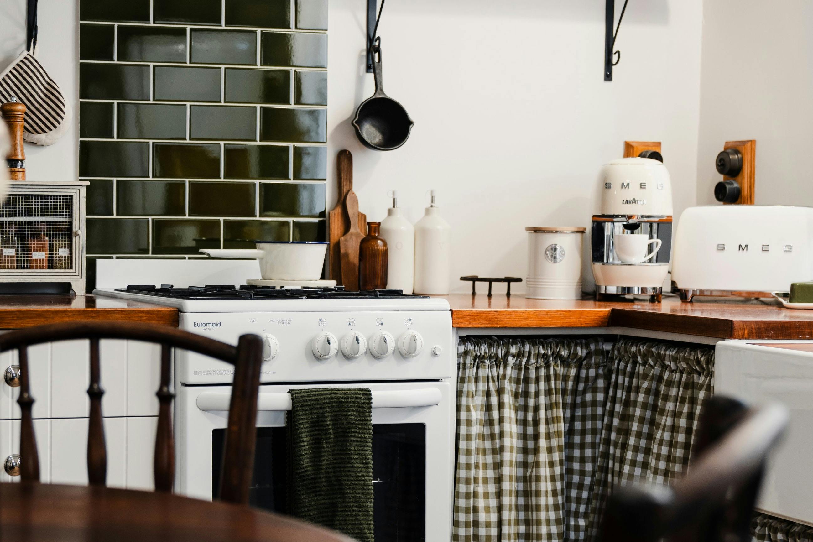 View of kitchen with green tiles