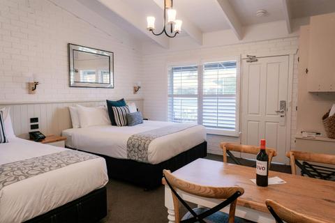 Beds and dining table in the studio apartment at Alzburg Resort