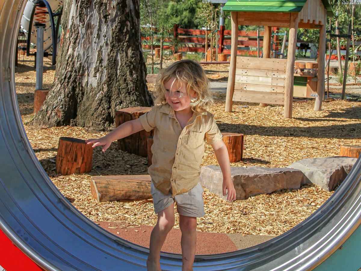 Child on hamster wheel in Apex Park playground