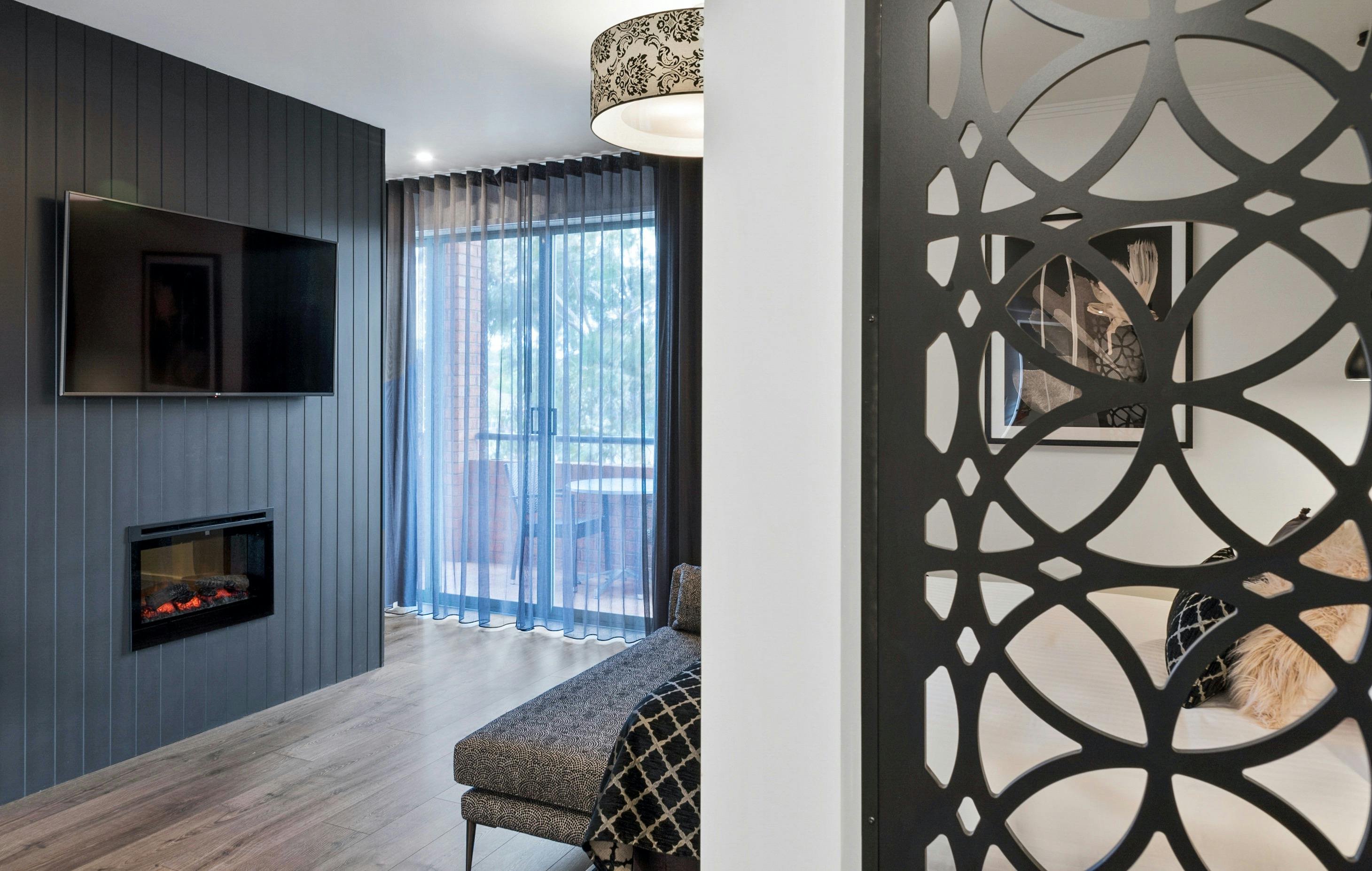 Studio Apartment, bed and fireplace looking out to balcony