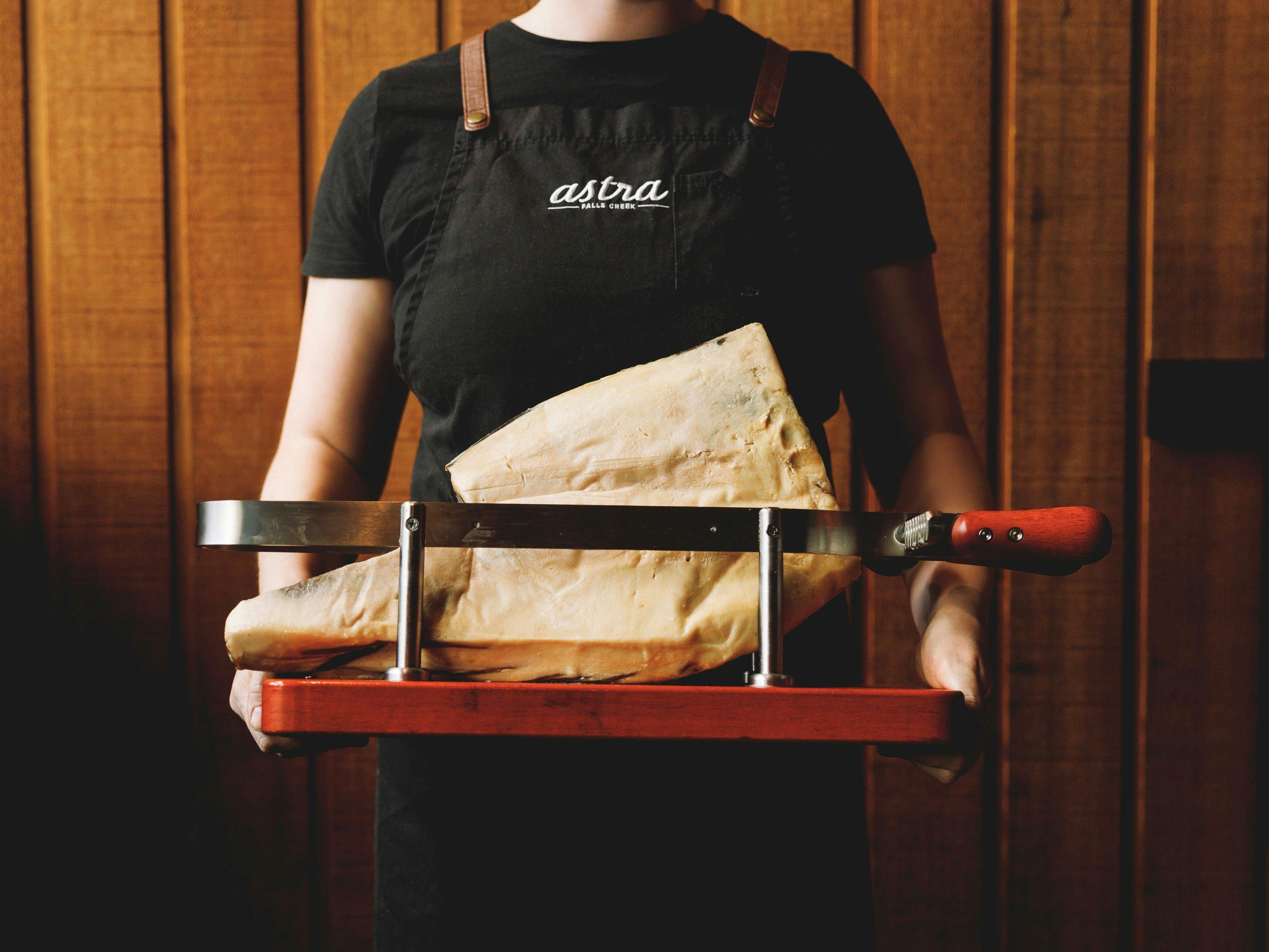 An image of Astra Bar & Restaurant Head Chef Monica holding produce