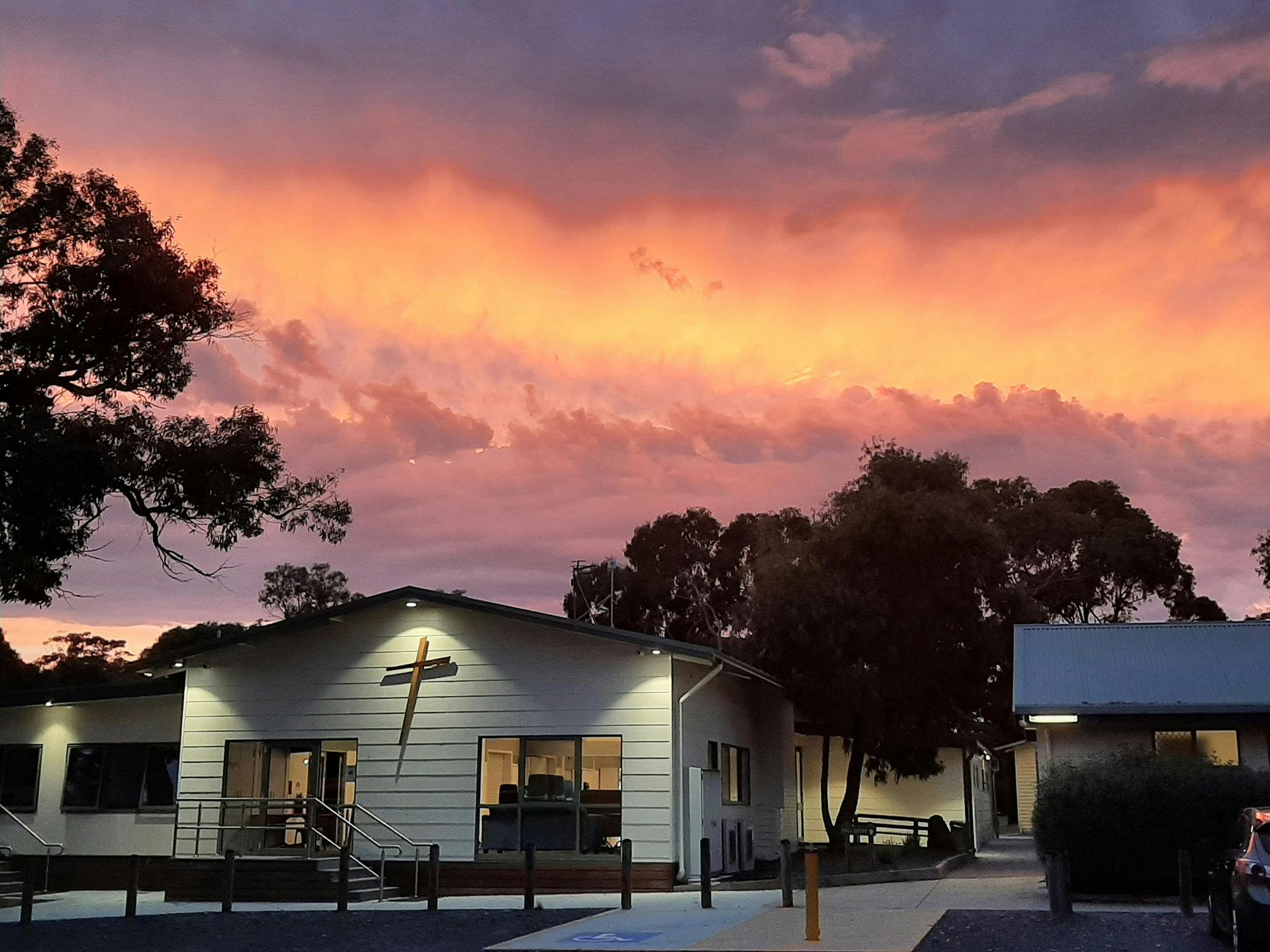 Pink and orange sunset behind main building