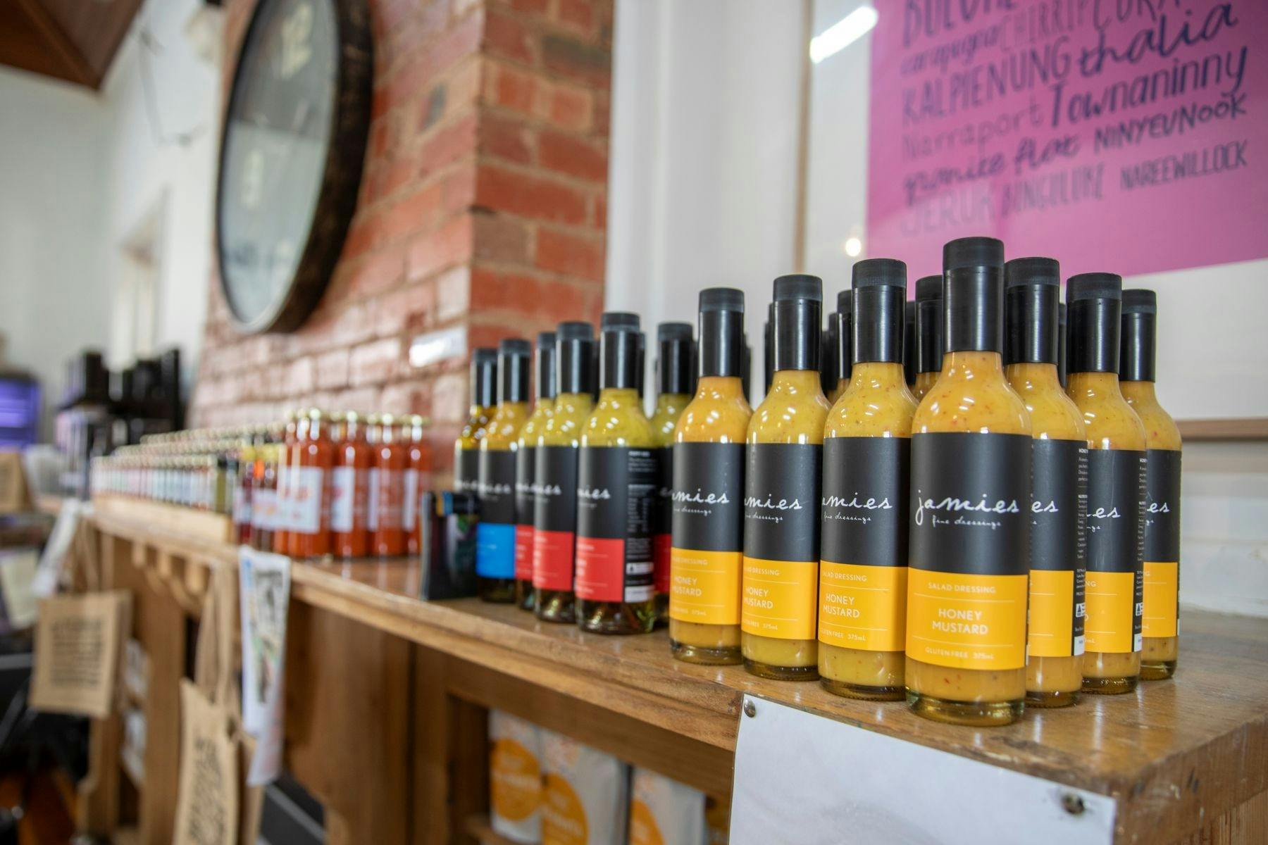 An open shelf with bottles of local produce