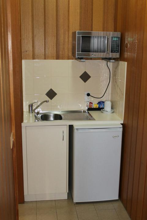 kitchenette with fridge and sink