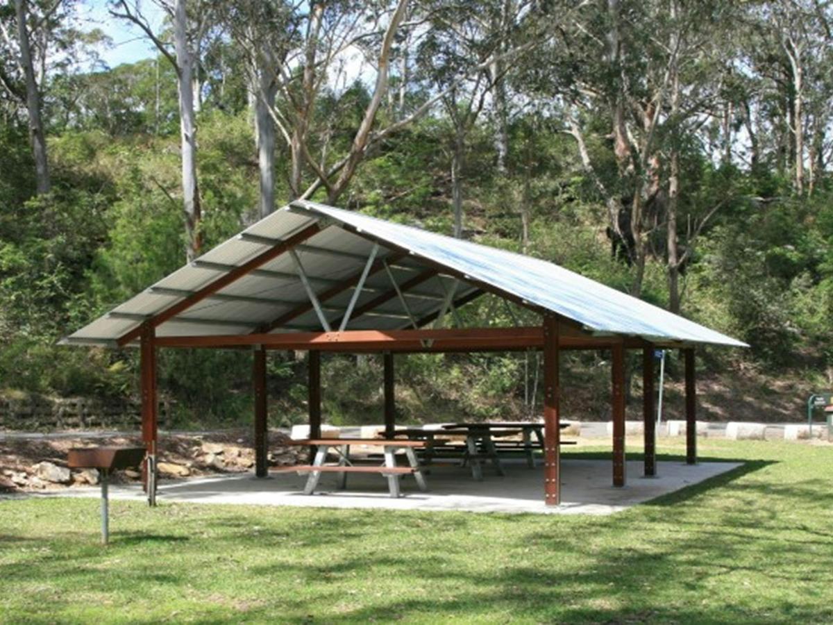 A large picnic shelter surrounded by trees at Haynes Flat picnic area in Lane Cove National Park.