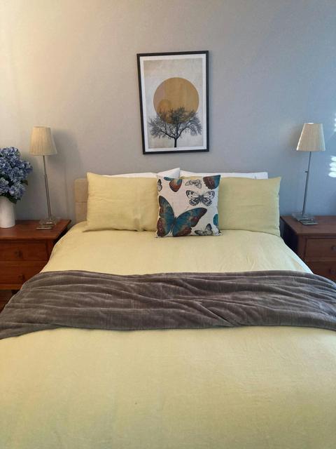 double bed inside a room with a picture frame on the wall