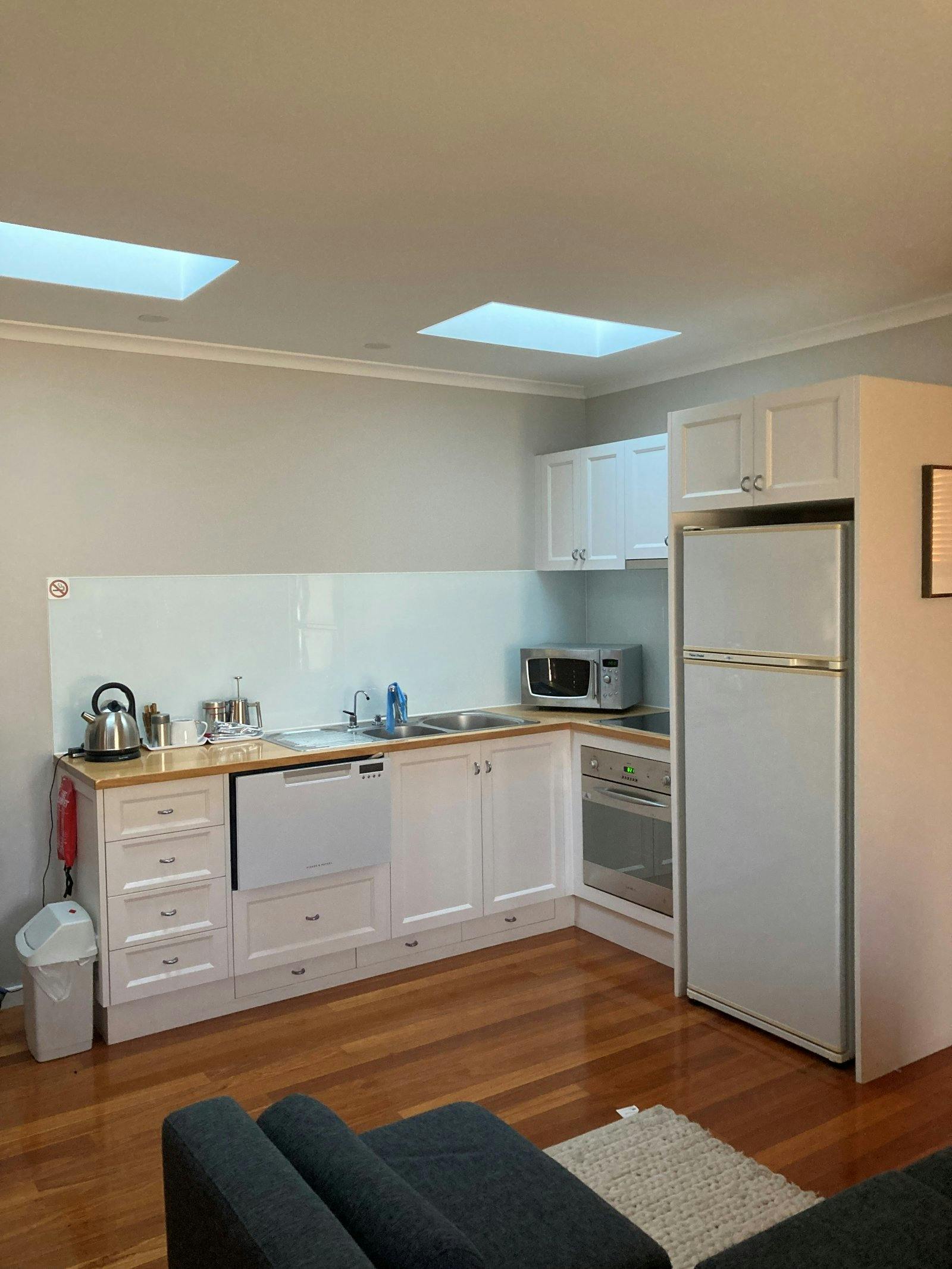 kitchen with fridge, kettle, microwave and sink