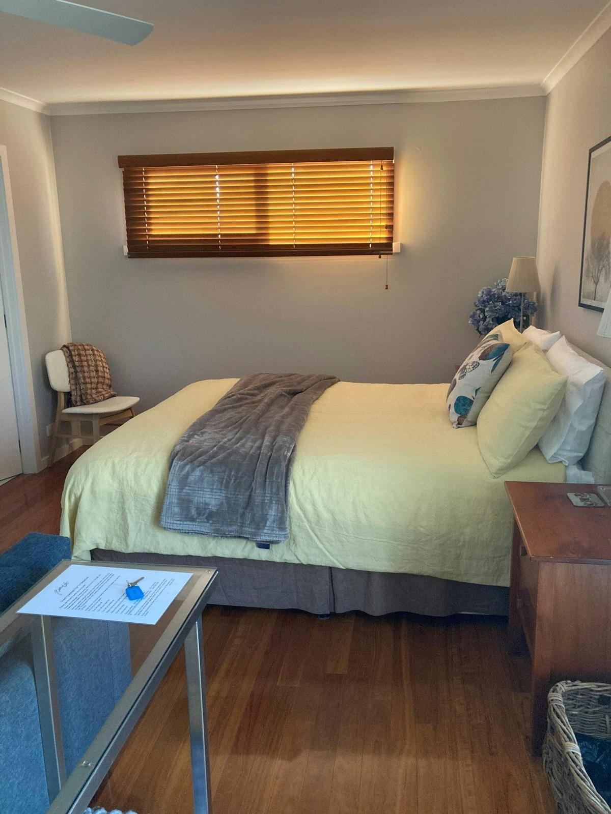 double bed inside a room with windows and picture frames on walls