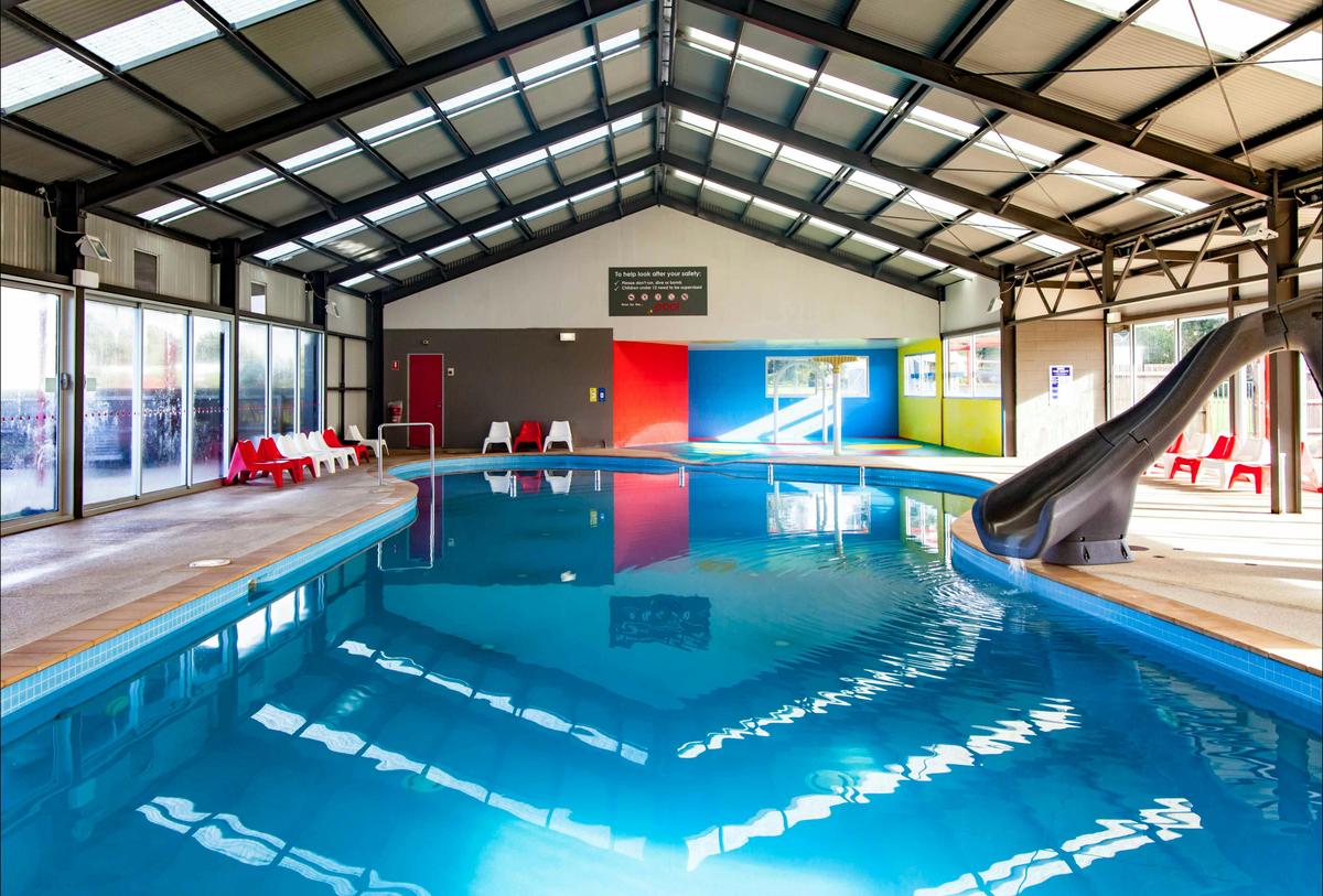 Heated swimming pool with slide
