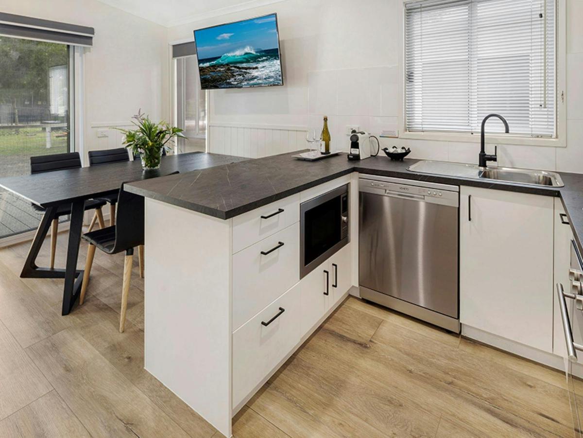 2 Bedroom Premium Villa Kitchen, dining table and television