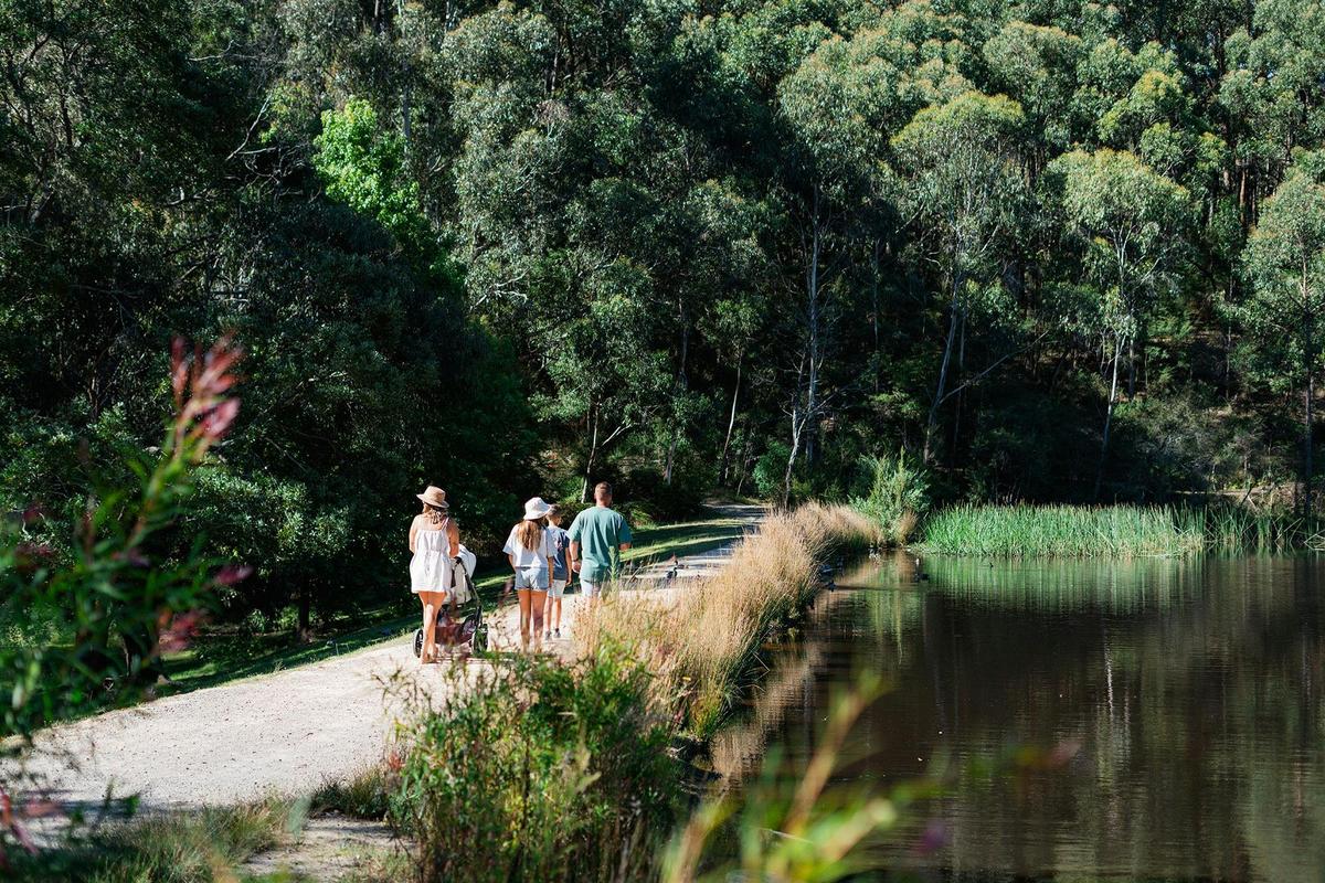 Family walking beside the on-site lake.