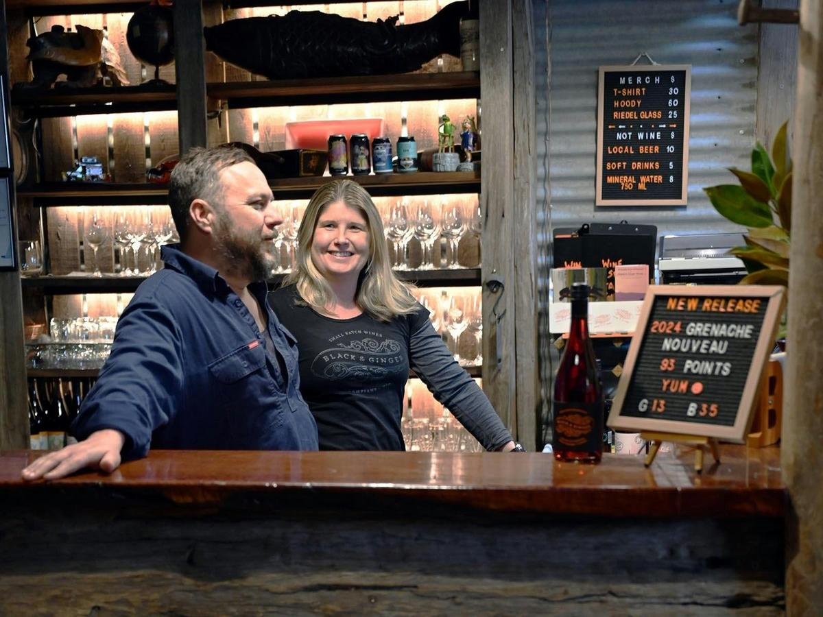 Hadyn and Lucy behind the bar at the wine shed