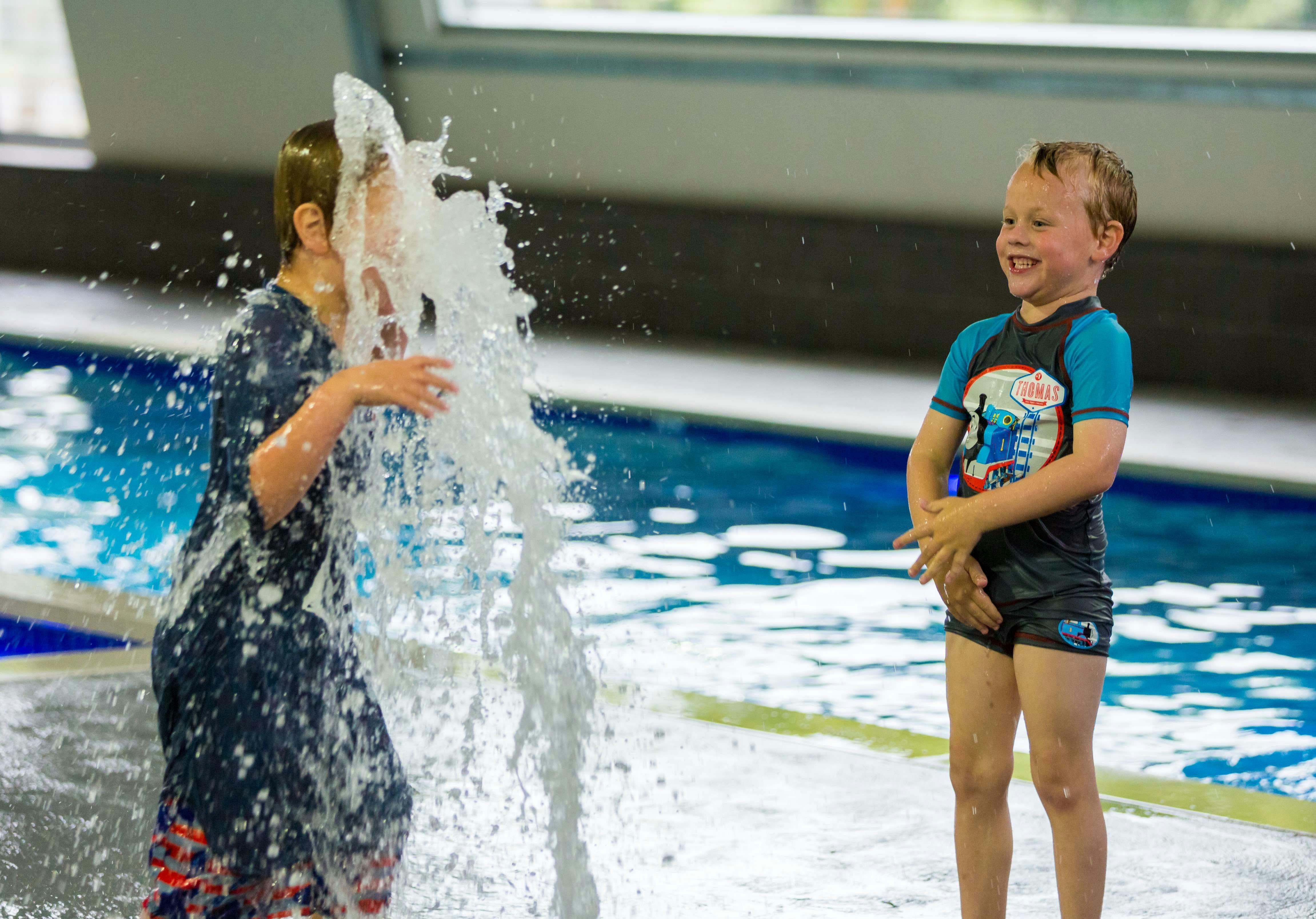 Kids cooling off and making a splash at the pool's splash pad
