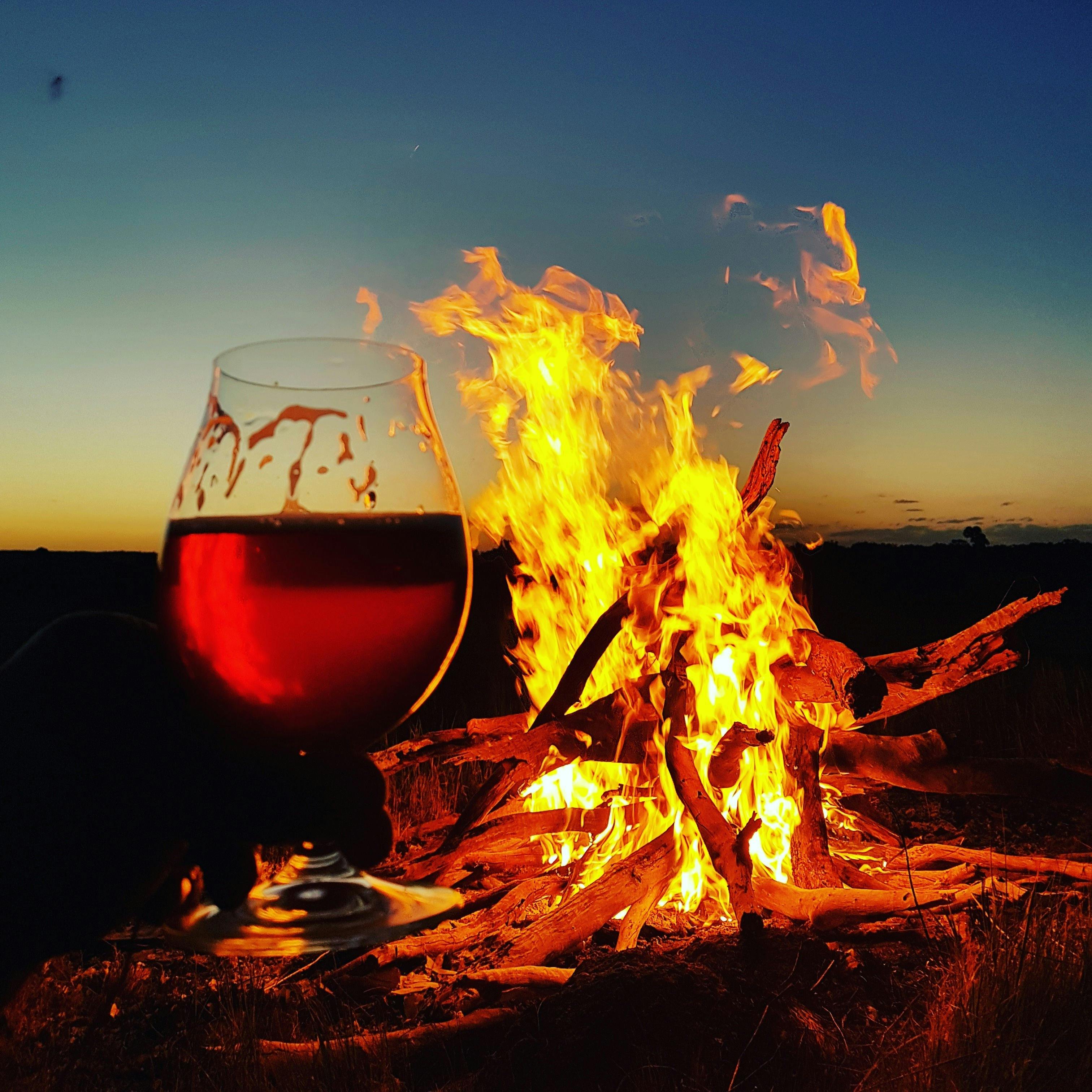 Belgian Dark Ale being enjoyed in the cooler months of winter by a campfire