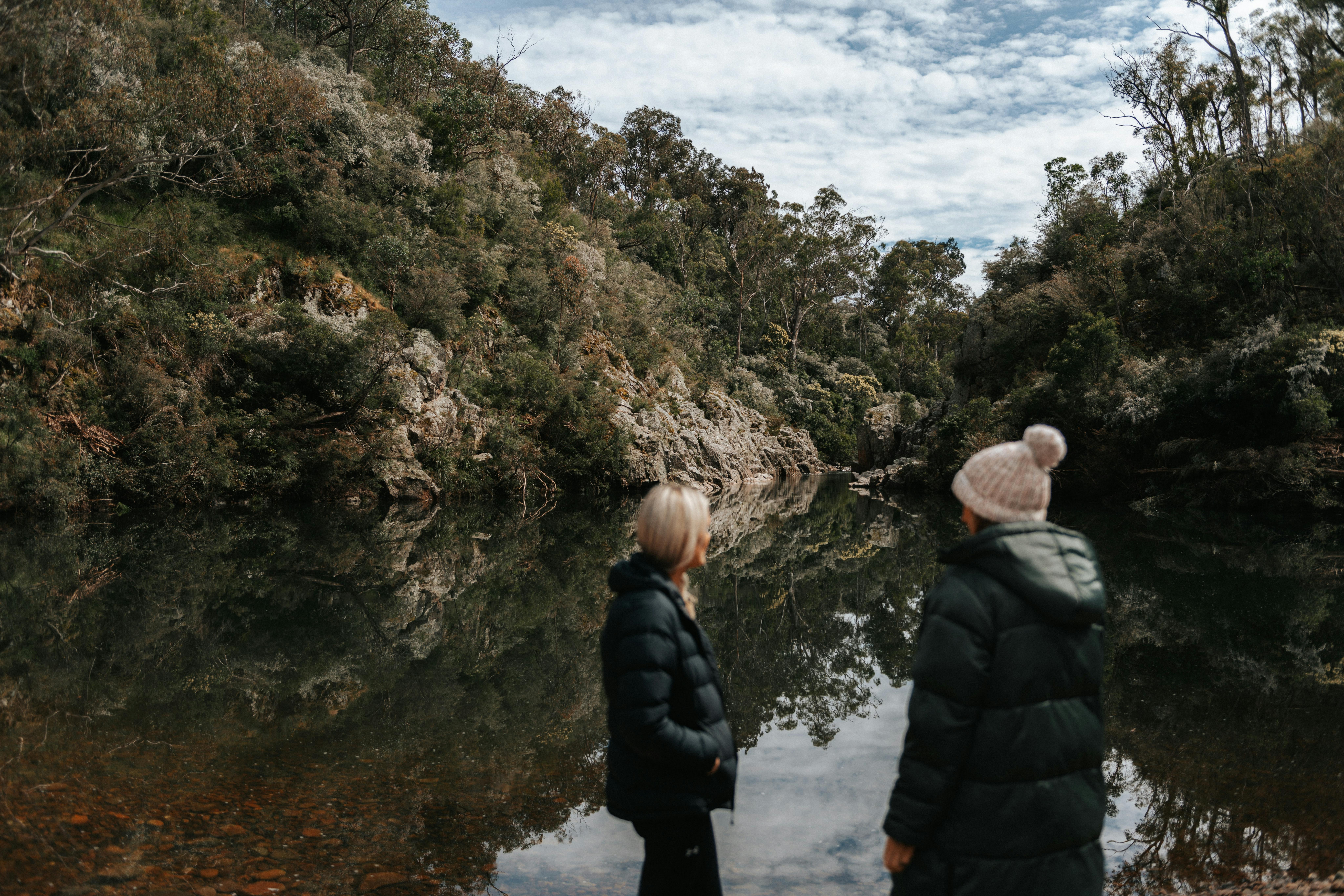 Two women look out to the Blue Pool