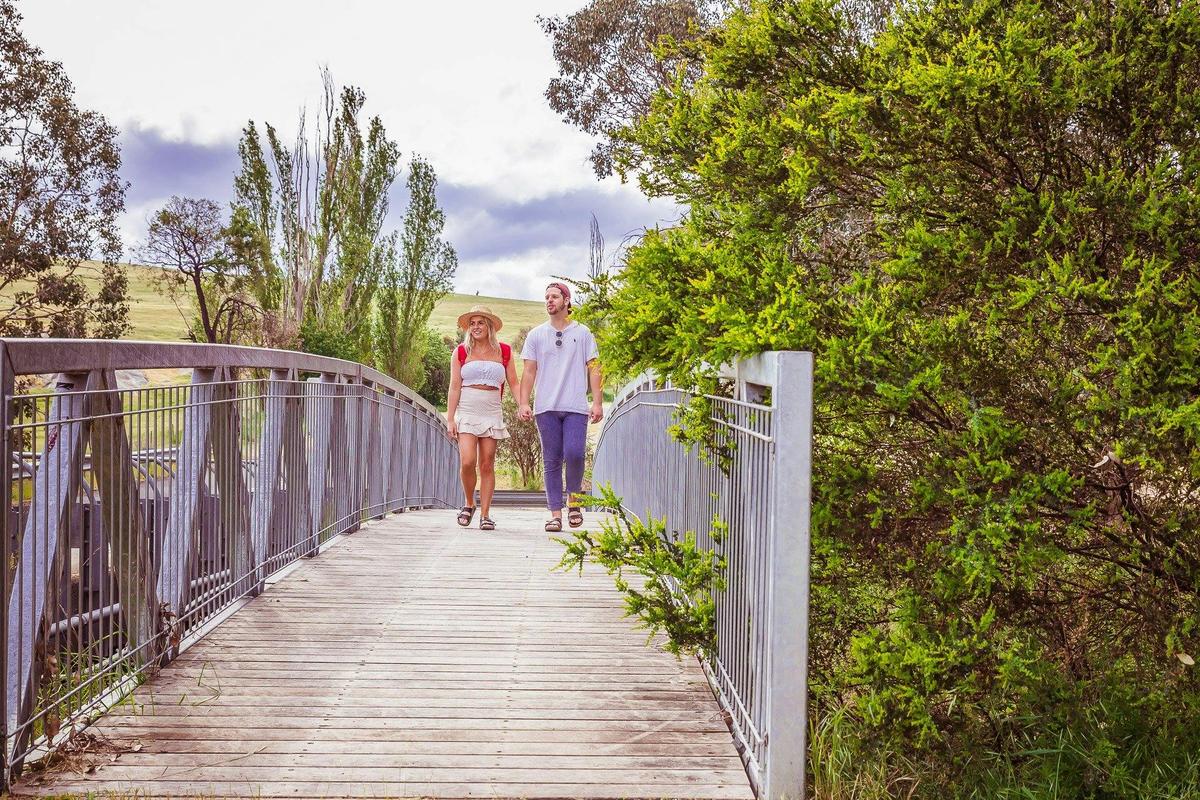 Couple walking across bridge
