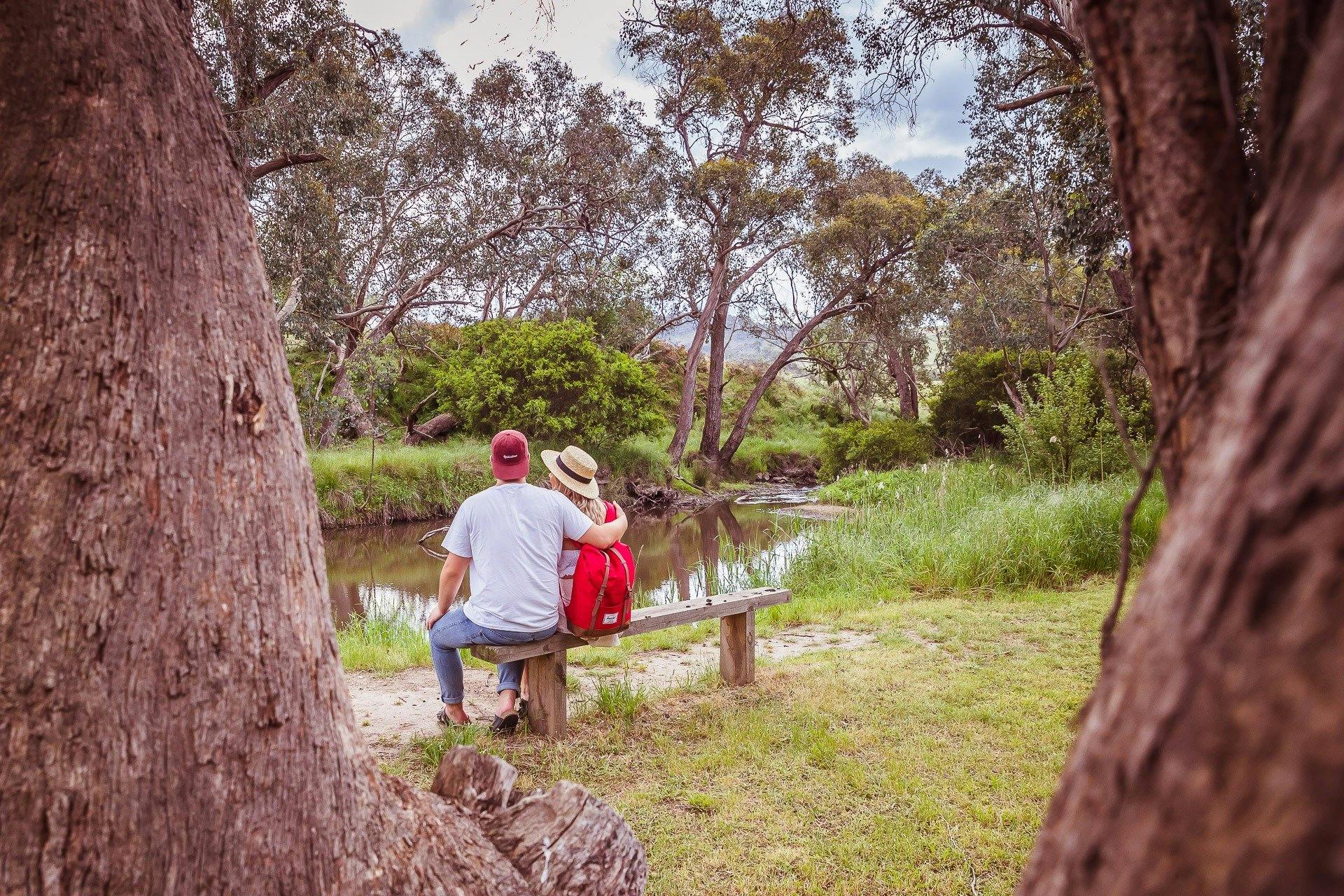 People viewing the waterway from a bench