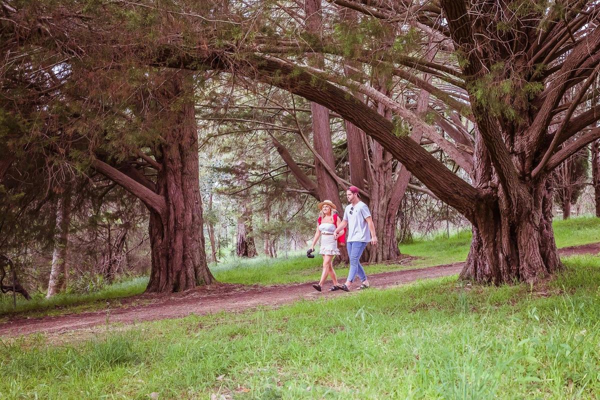Couple walking across dirt trail