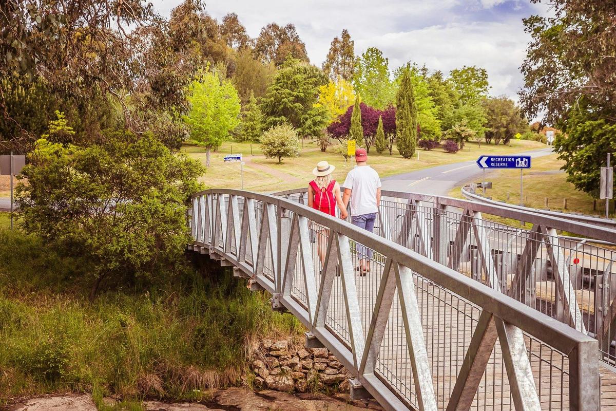 Couple walking over bridge