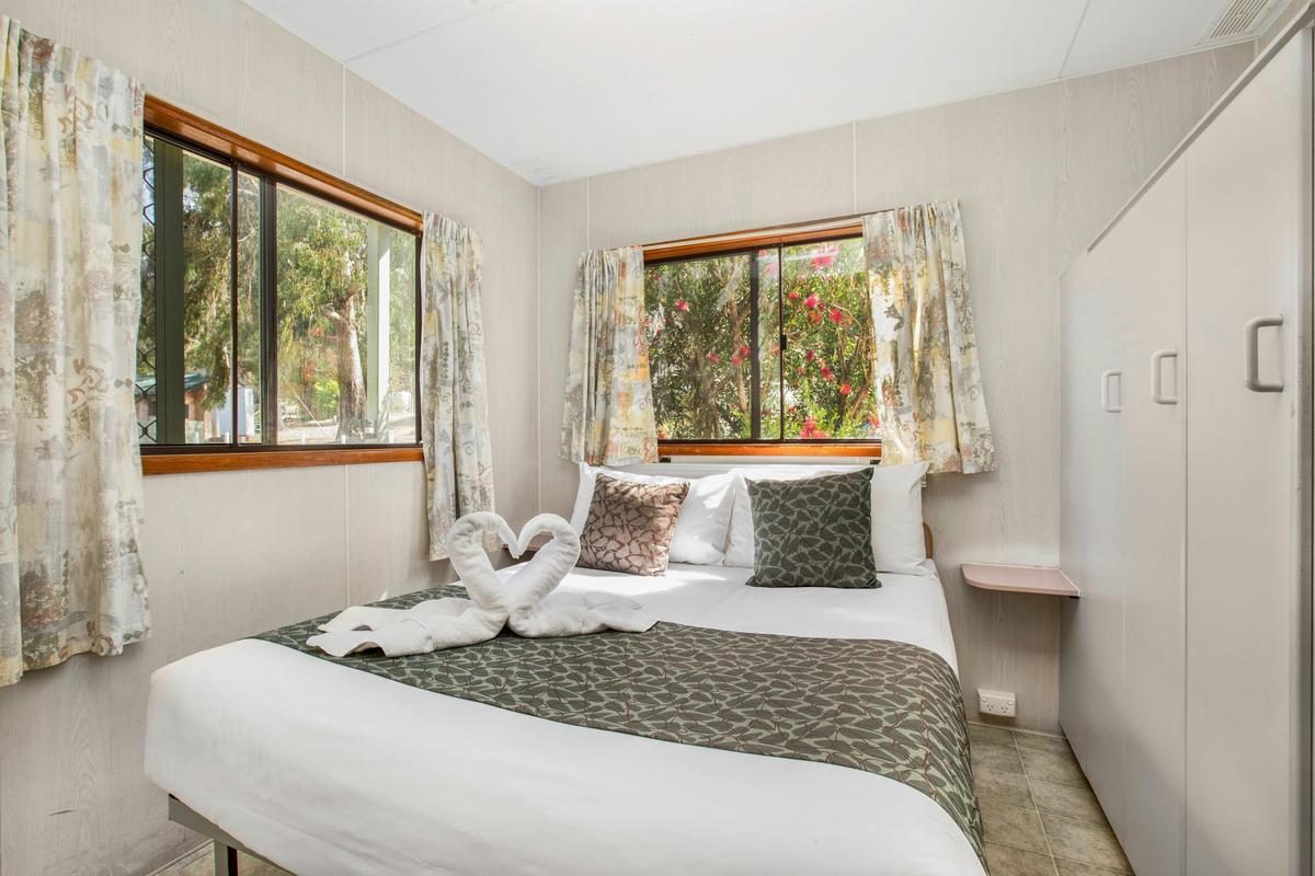 Queen bed in the Two-Bedroom Budget Cabin