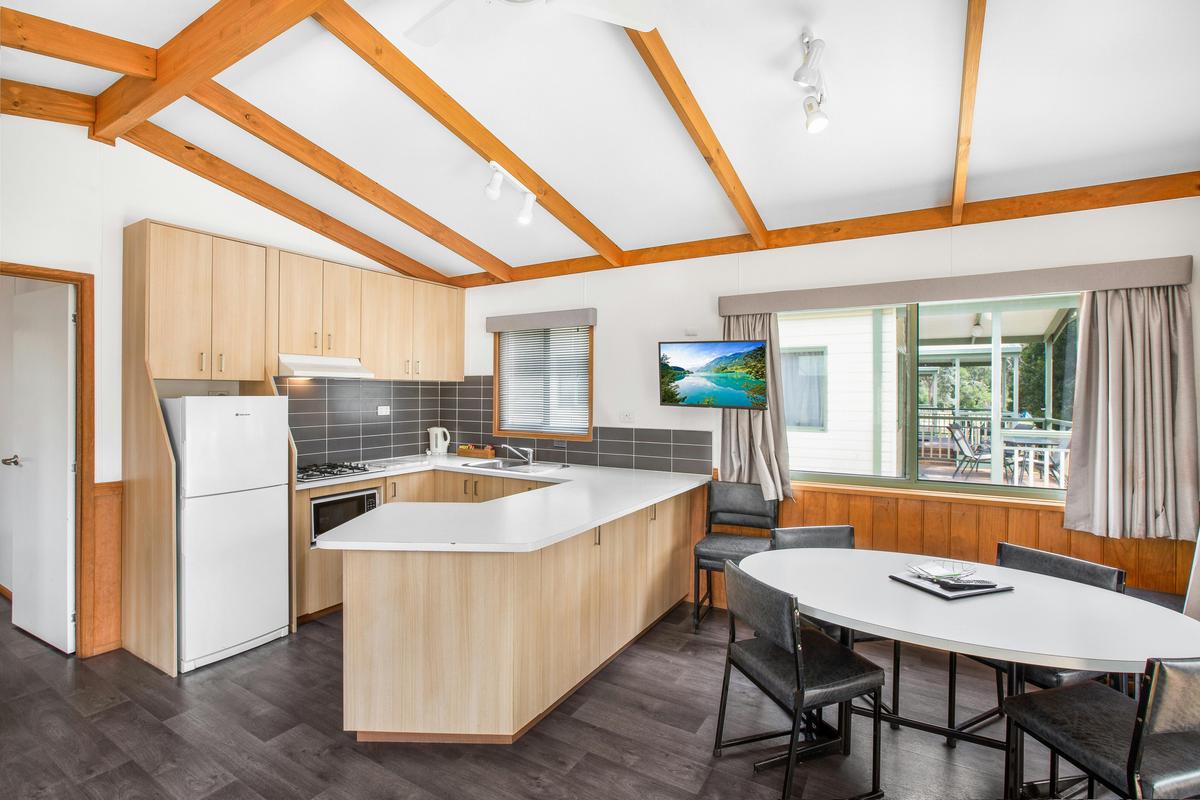 Kitchen and dining area in the Three-Bedroom Deluxe Cabin