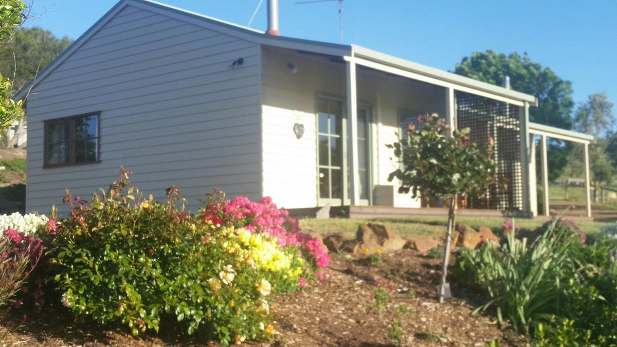 The two cottages sit nestled in their own garden in the side of the hill on the rural property.