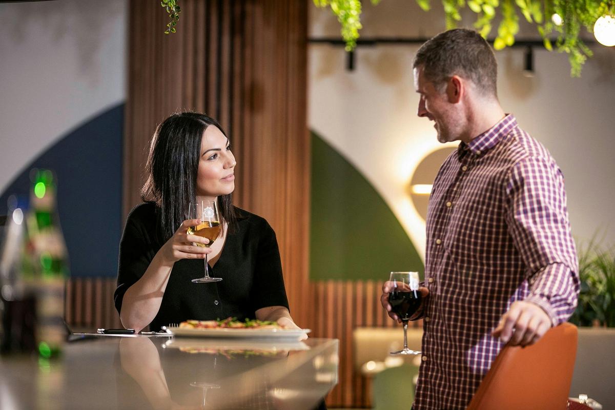 Couple eating and drinking in Dandelion Lounge & Eatery