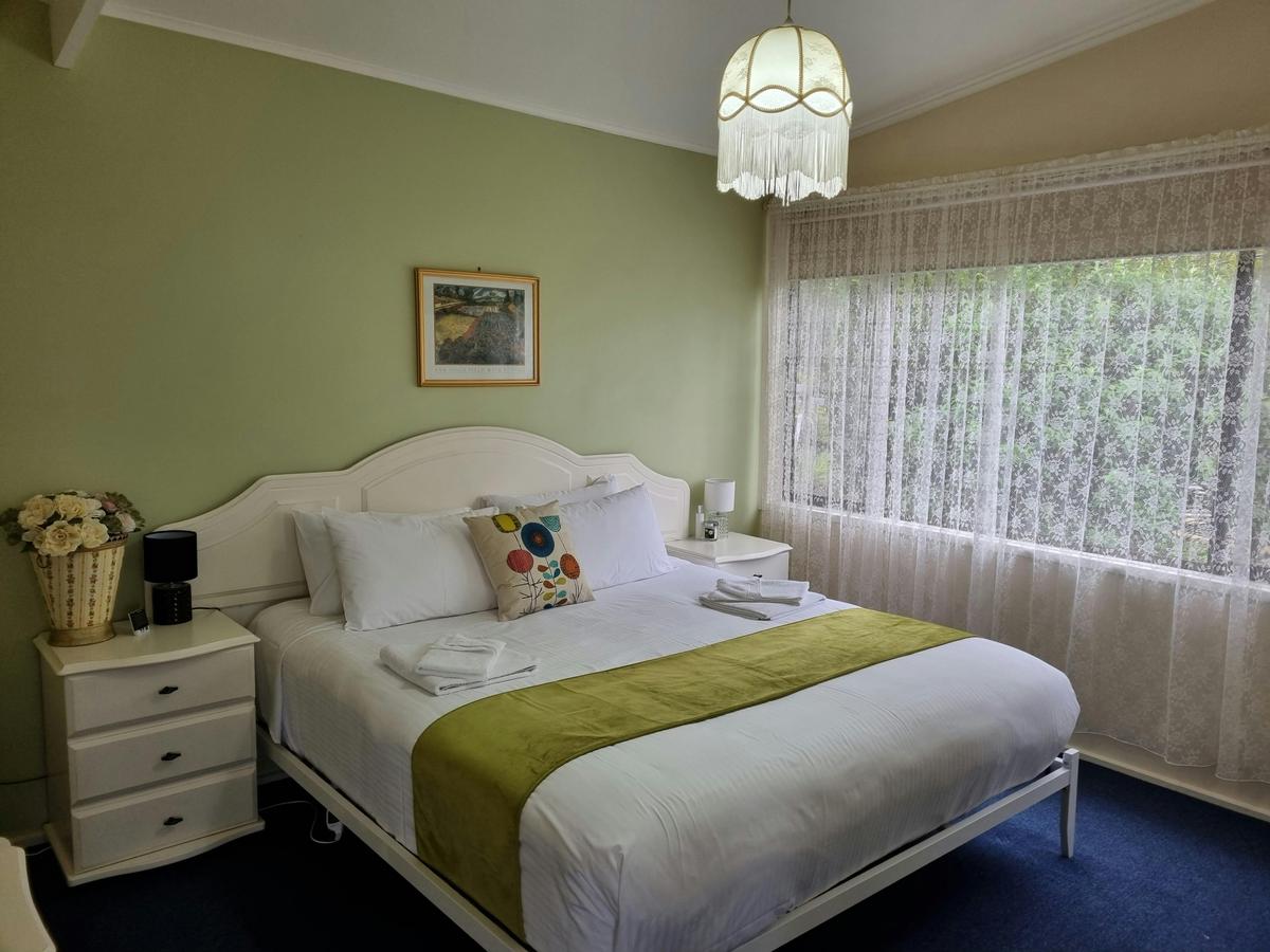 Bedroom 2 with king bed in Beech Forest Cottage