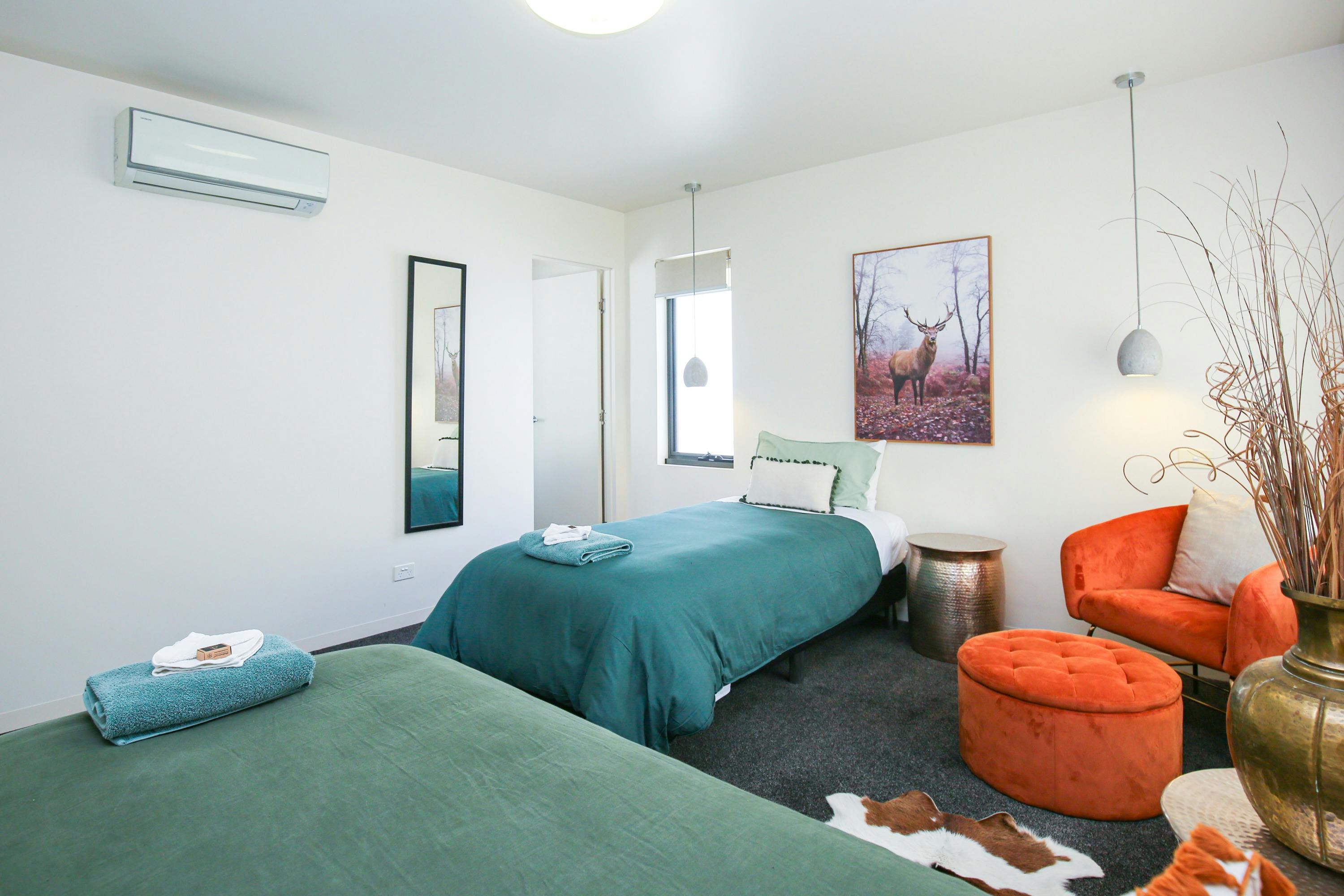 Bedroom Three Upstairs with two single beds, chair and mirror