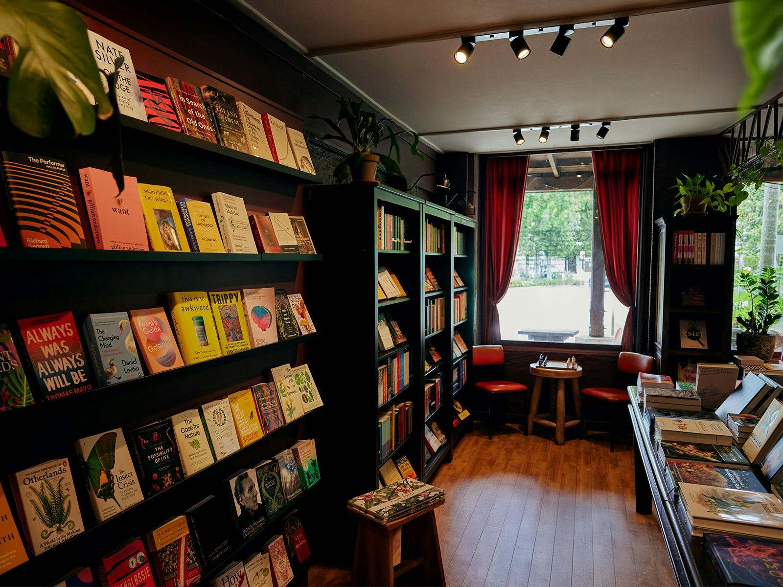 Interior of the store with books lining the shelves and a chessboard in the corner