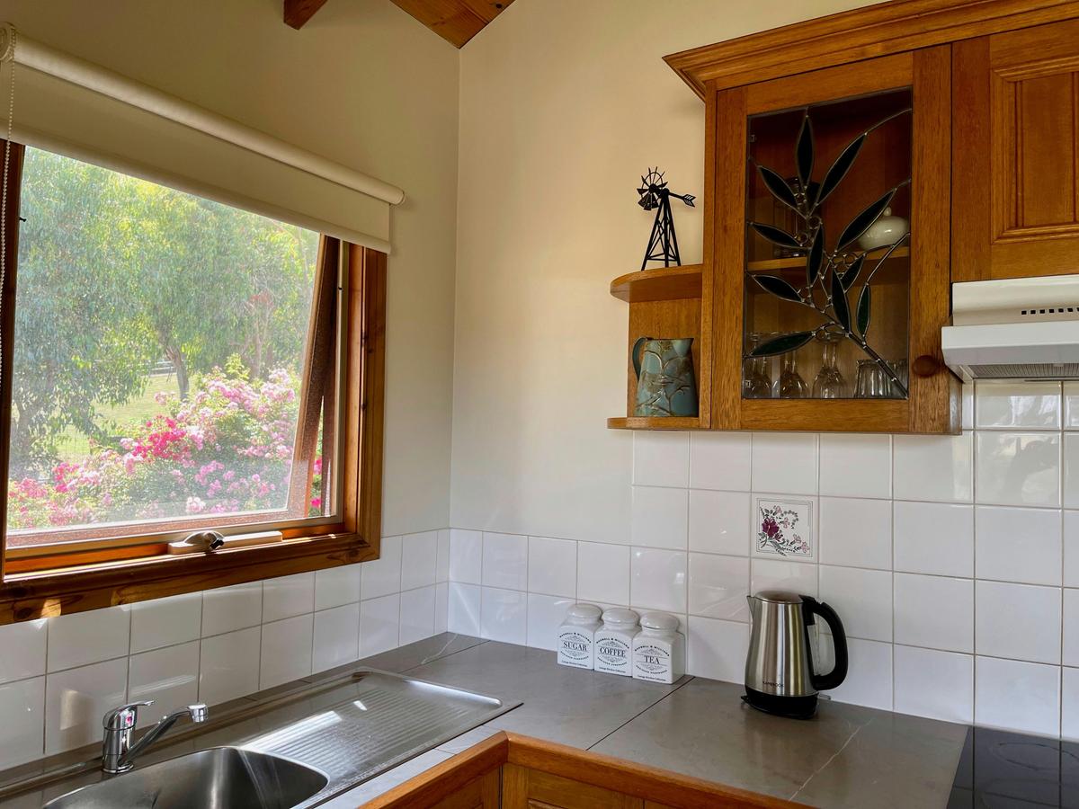 A corner of the kitchen of Wattle Cottage including a sink and a kettle