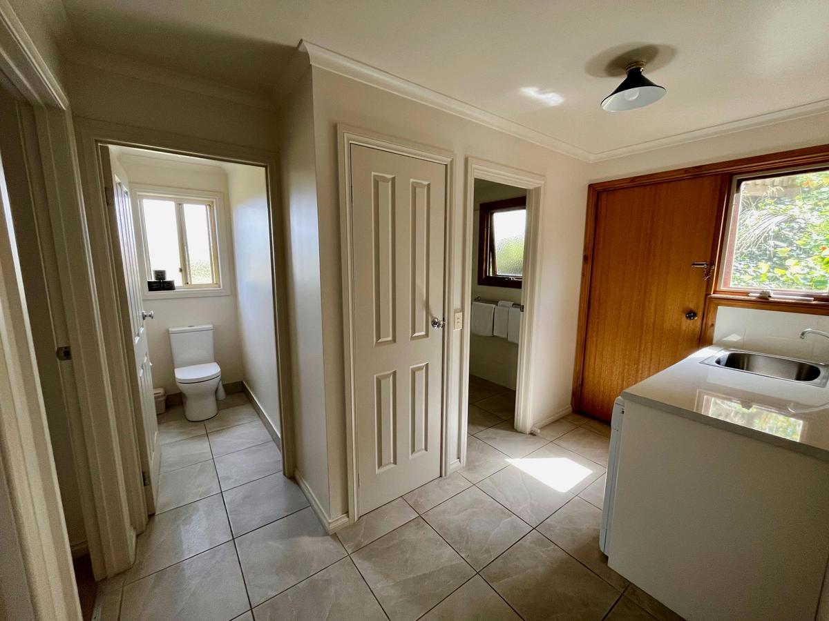 A room of Wattle Cottage featuring a toilet and a sink