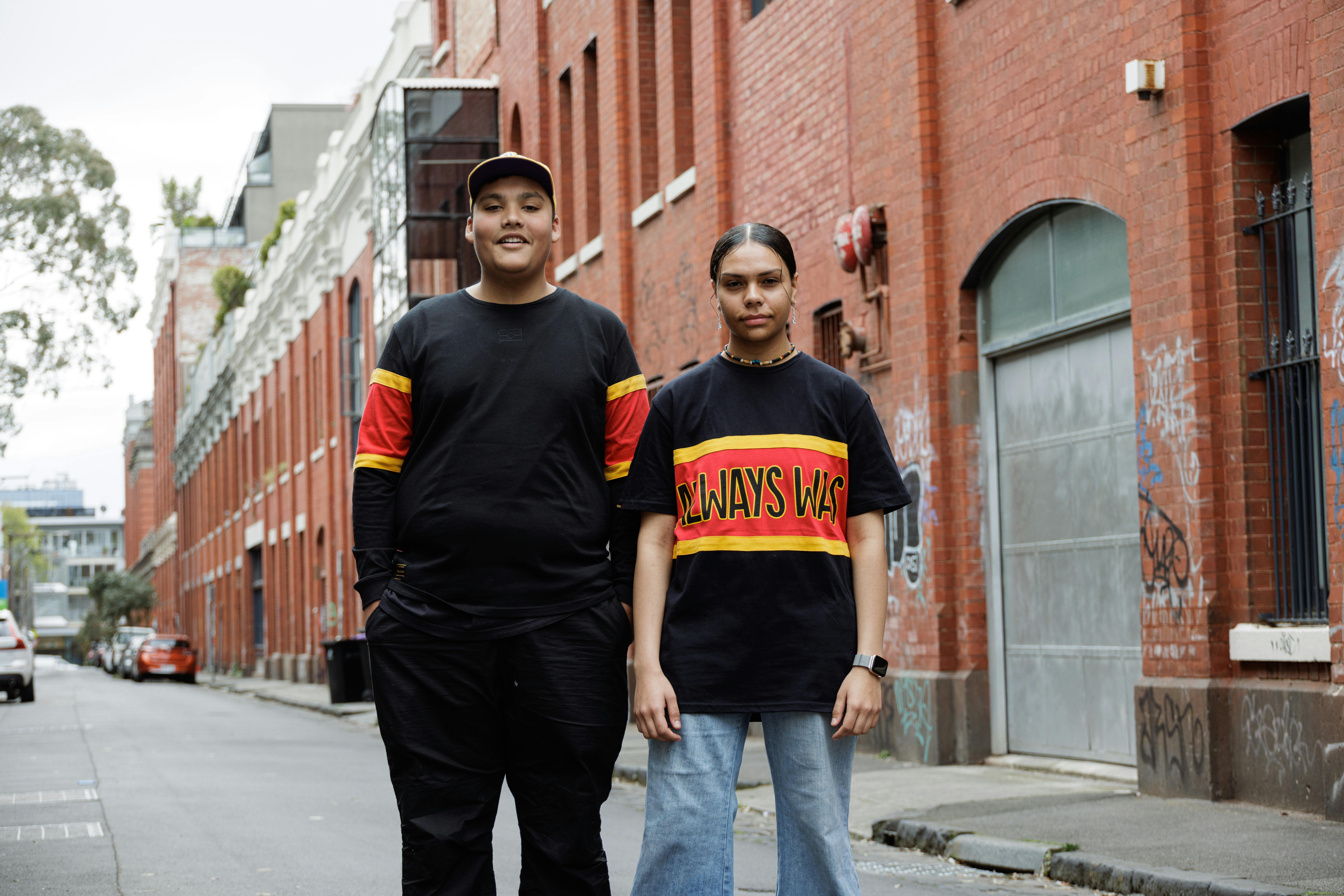 two people standing in a laneway wearing clothing the gaps' products