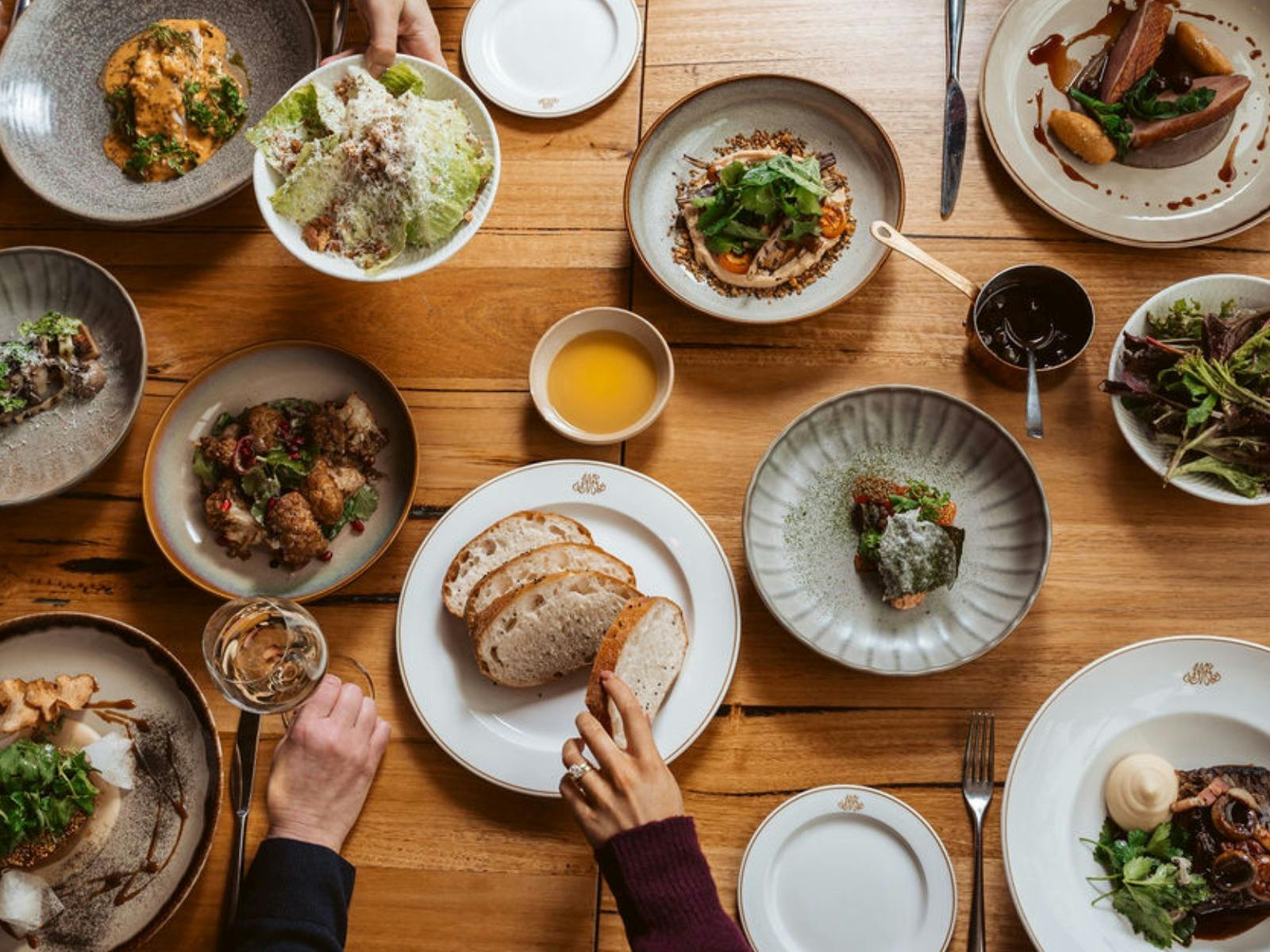 Variety of dishes placed on a wooden table