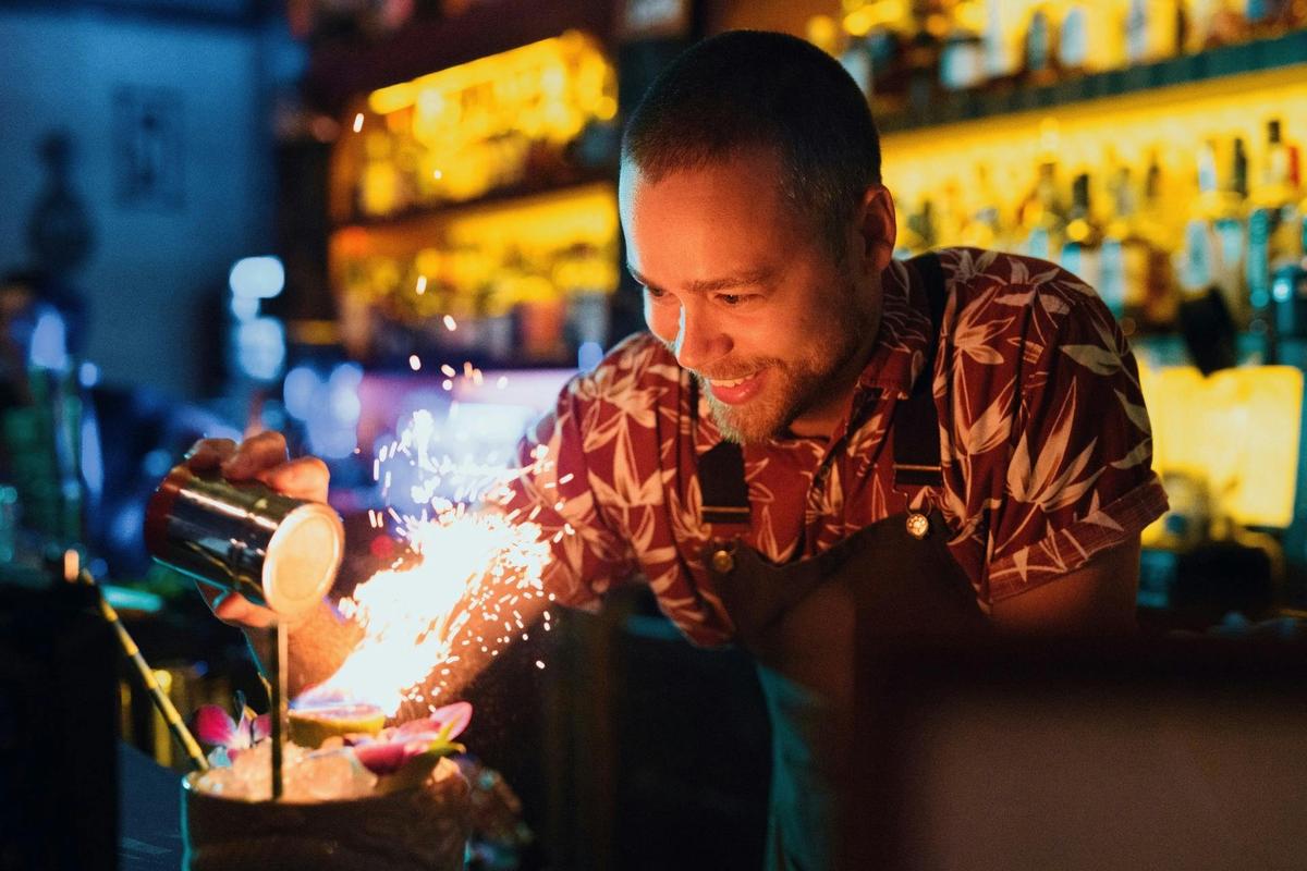 Skilled bartender crafting cocktails at Melbourne laneway bar