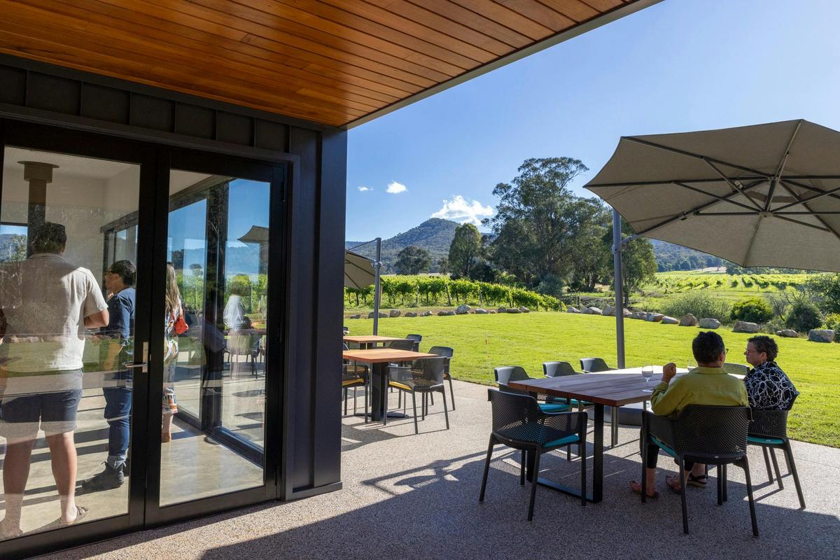 A view of the outdoor seating with guests under the umbrellas