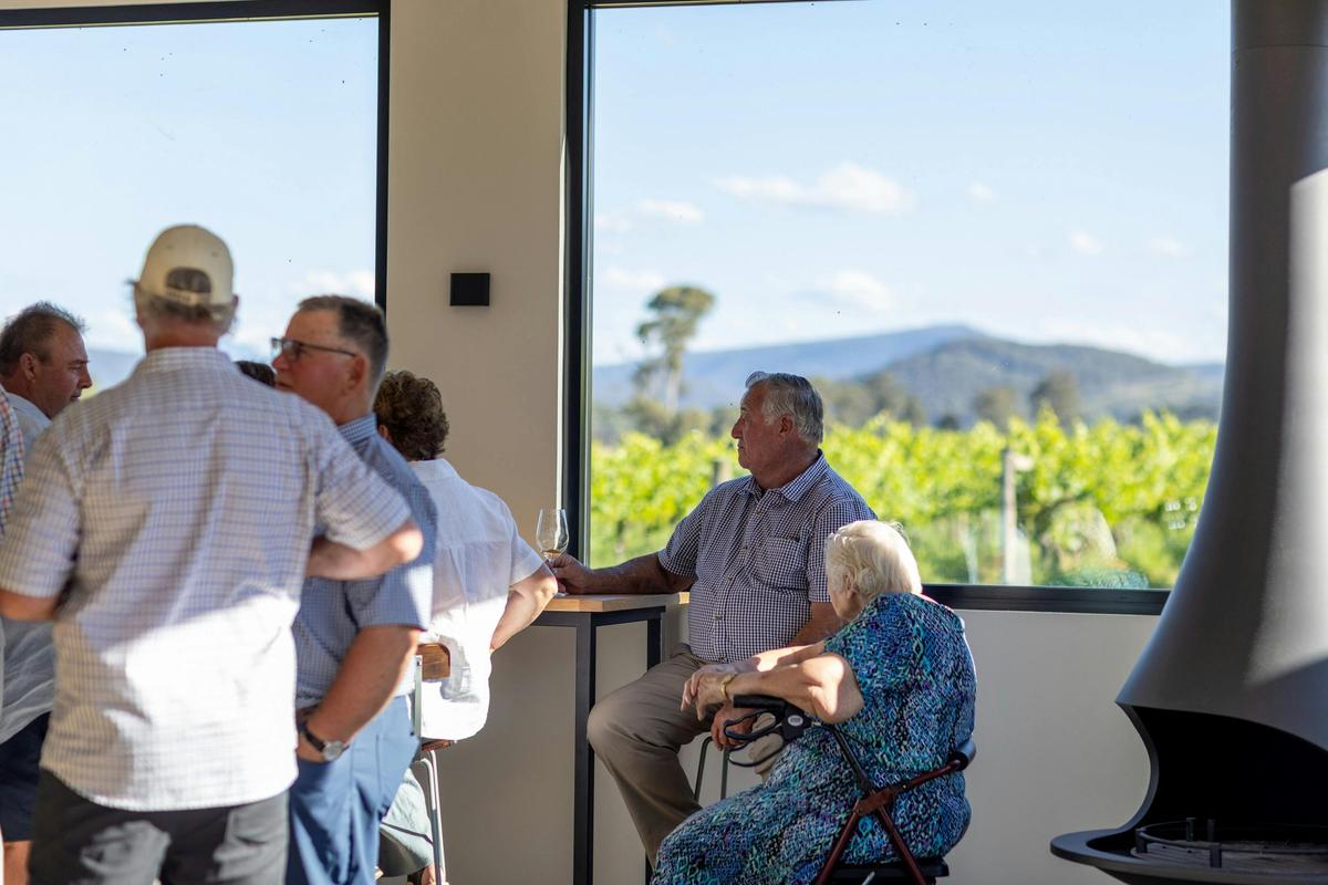 Guests sitting by the windows enjoying the view across the vines.