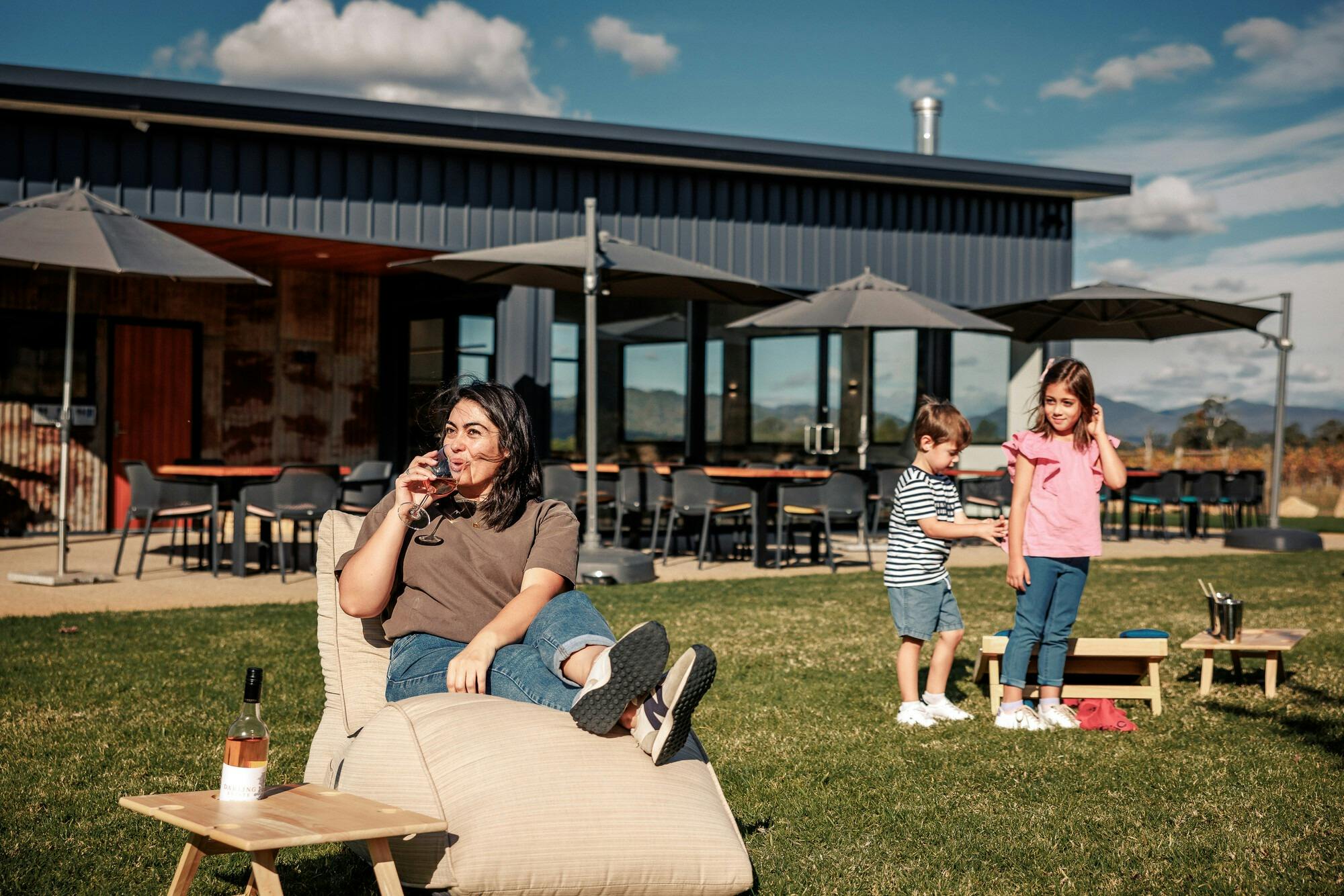 sitting on a beanbag on the lawn enjoying a glass of wine and milkshakes