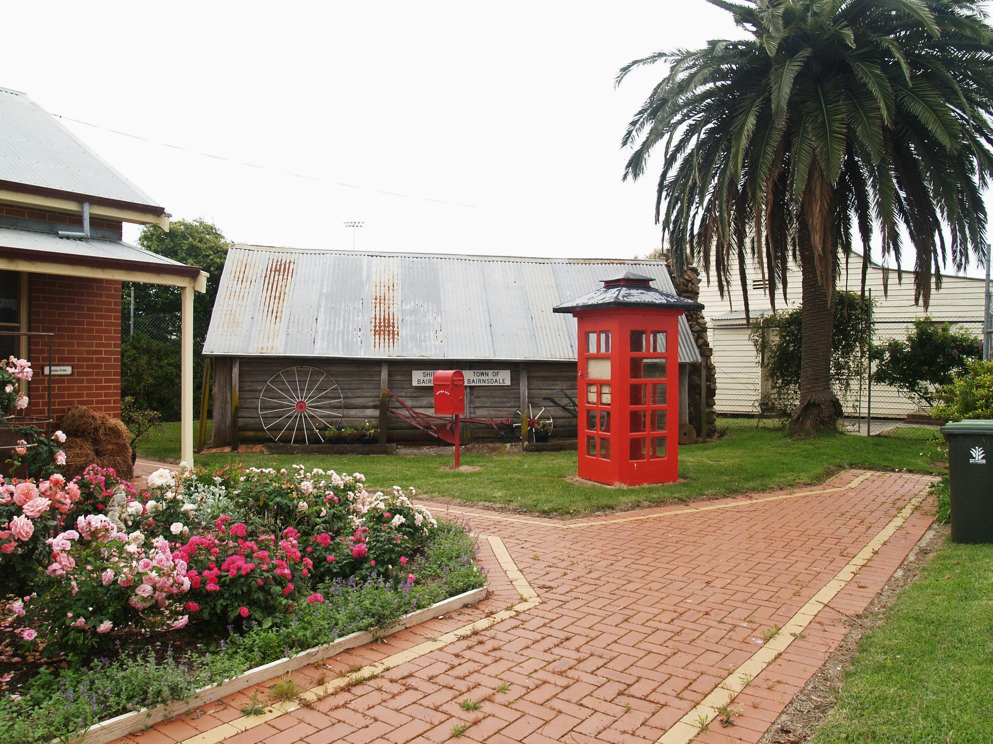 The old red telephone box with 'Calajero' log hut behind
